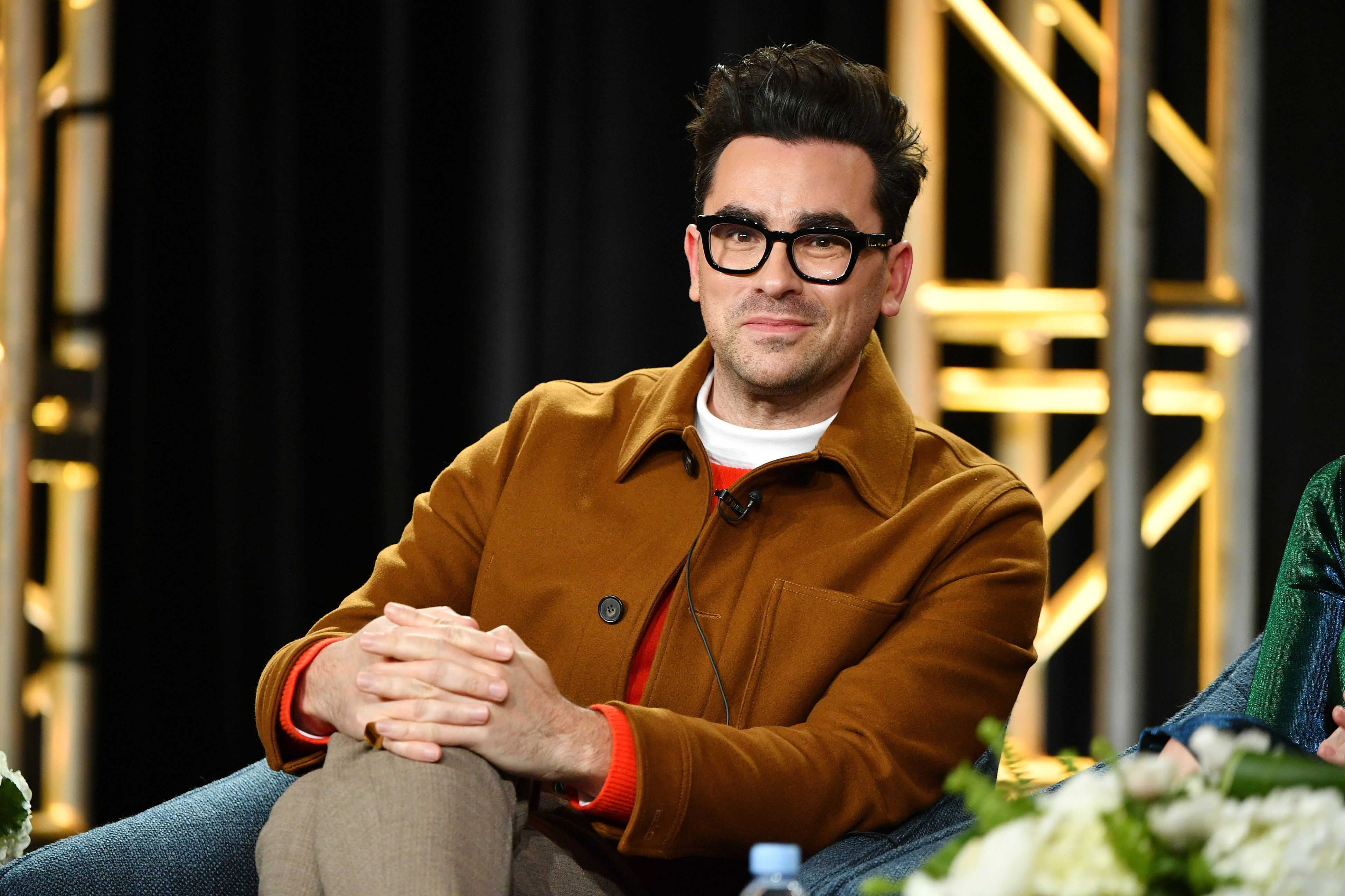 Dan Levy pictured speaking onstage at Pop TV segment of the 2020 Winter TCA Press Tour, 2020, California. | Photo: Getty Images