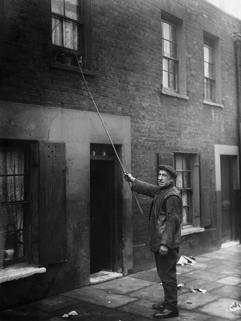 Knocker-upper, East London, 1929. Image Credit: Getty Images Knocker-upper, East London, 1929. Image Credit: Getty Images