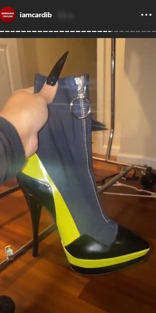 Cardi B flaunting her neon green boots on her Instagram story. | Photo: Instagram/iamcardib