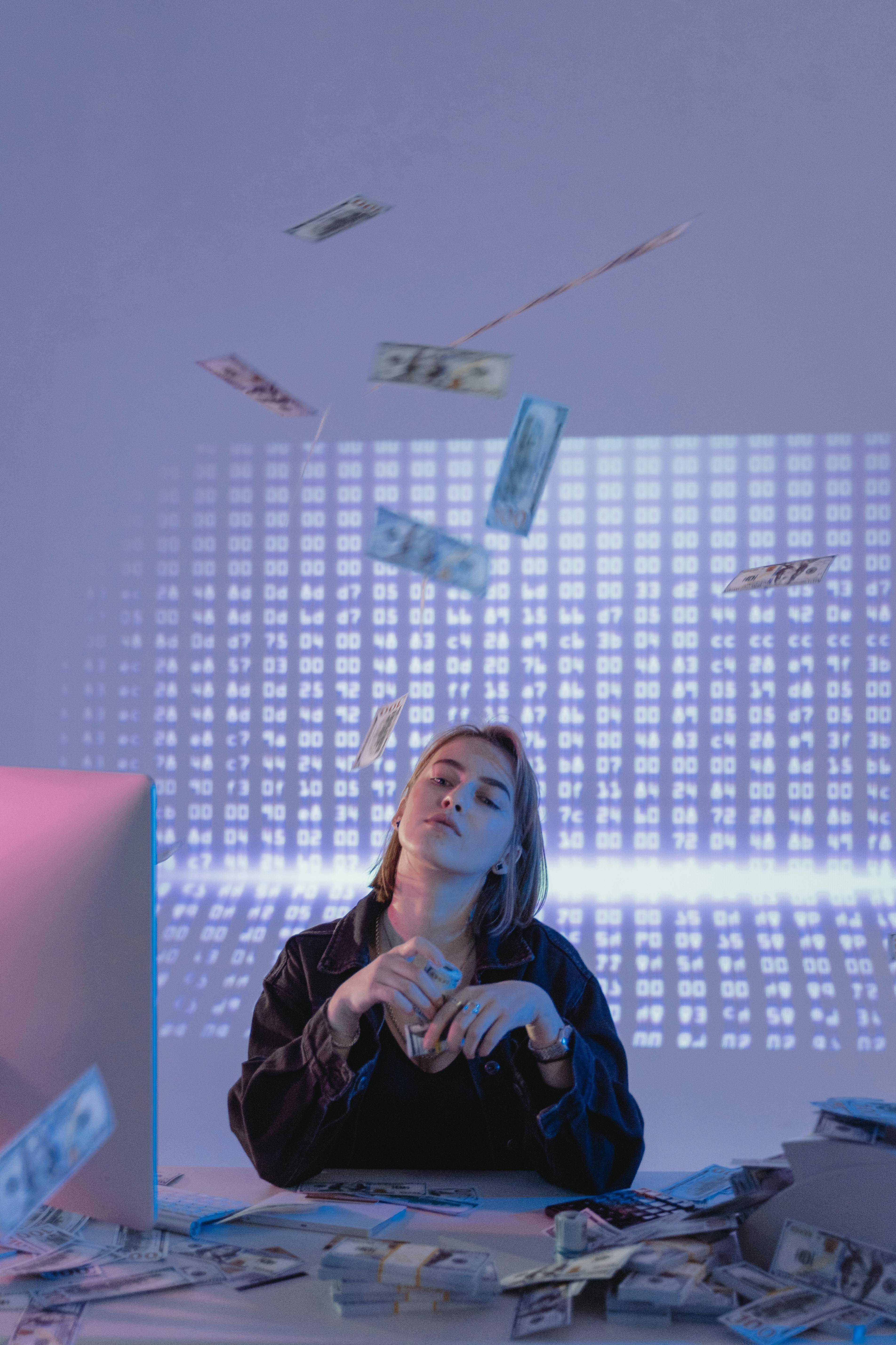 A woman throwing money around | Source: Pexels