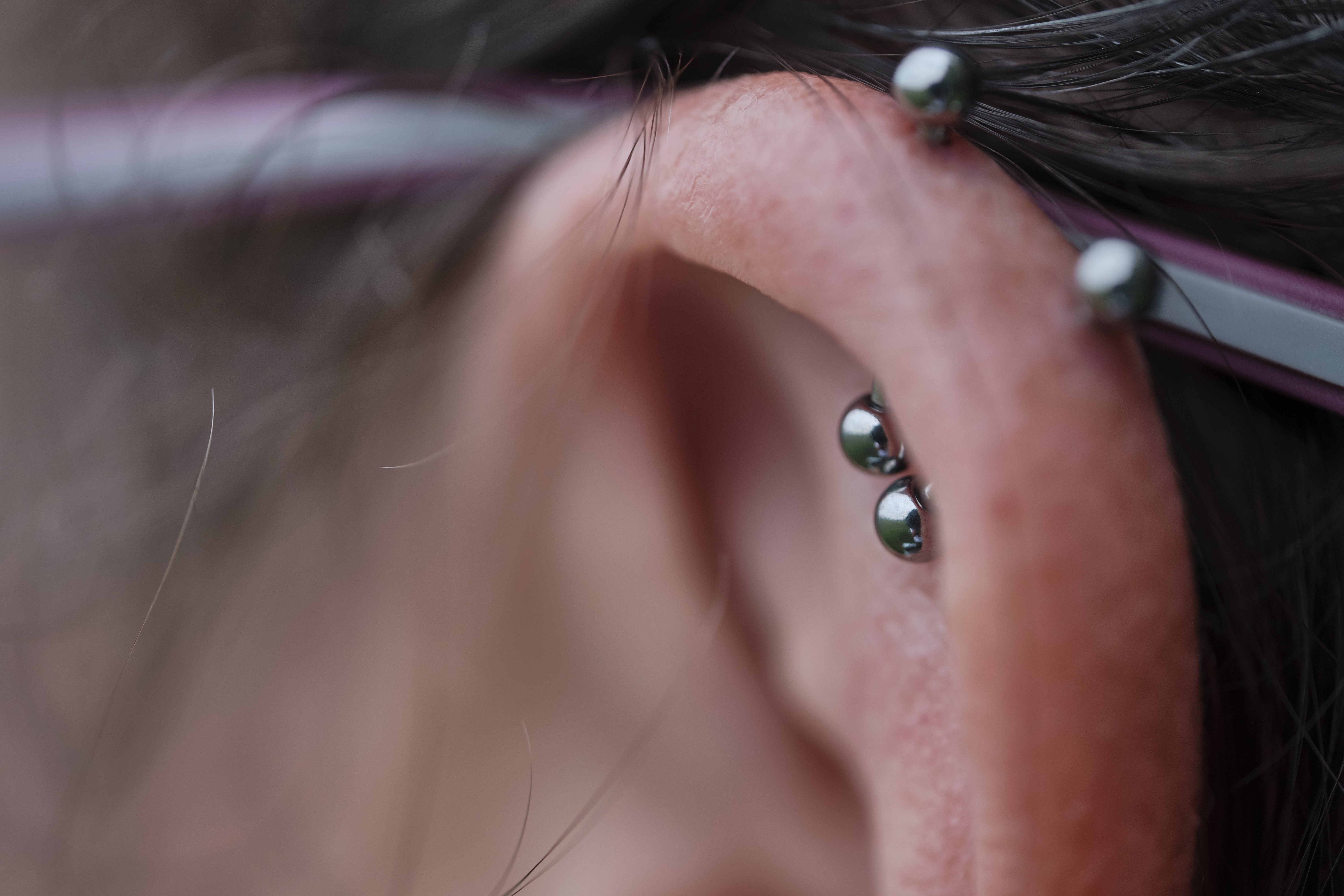 A close-up of a woman with a double helix piercing | Source: Getty Images