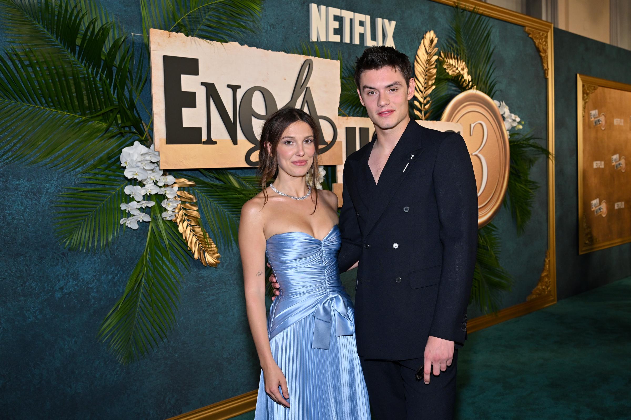 Brown poses with "Enola Holmes 3" co-star Louis Partridge during the New York premiere. While the cast gathered to celebrate the film's release, much of the online discussion centered on Brown's red carpet style and her coordinated appearance with Bongiovi. | Source: Getty Images