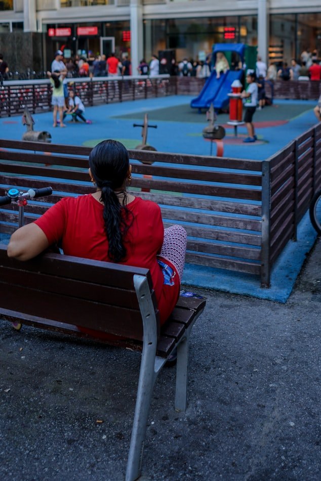 A woman watching children in the playground | Source: Unsplash
