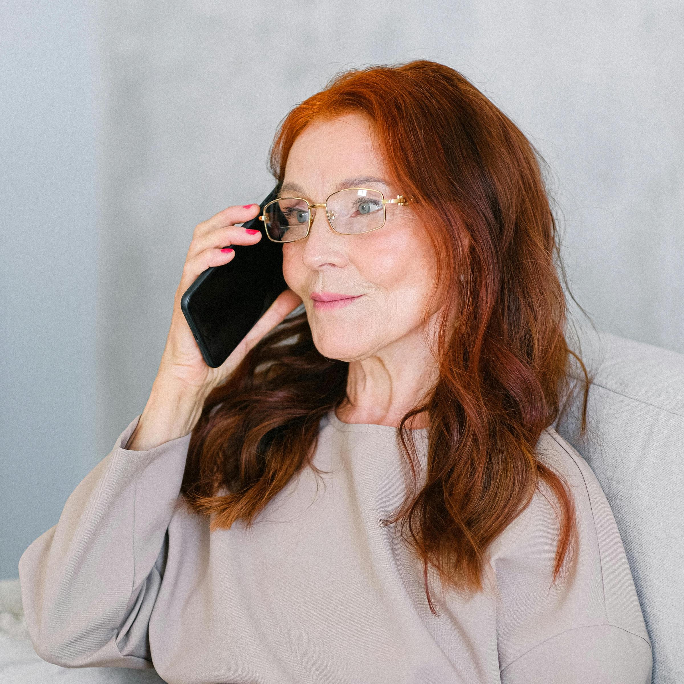 An older woman answering a phone call | Source: Pexels