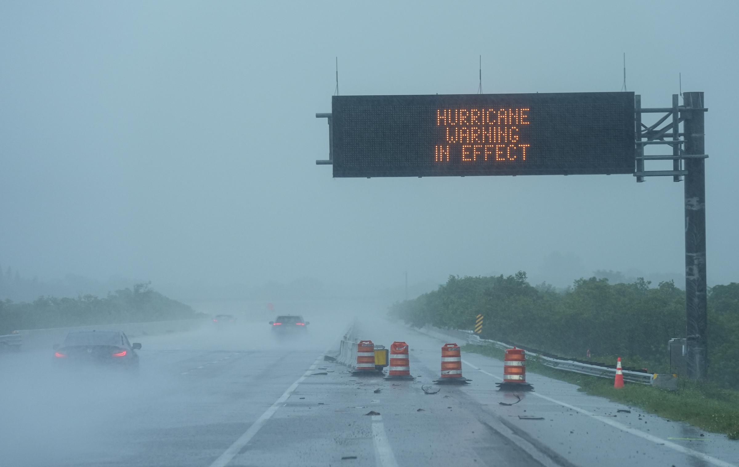 A warning sign appears as Hurricane Milton bears down on the Gulf Coast in Sarasota, Florida, on October 9, 2024 | Source: Getty Images