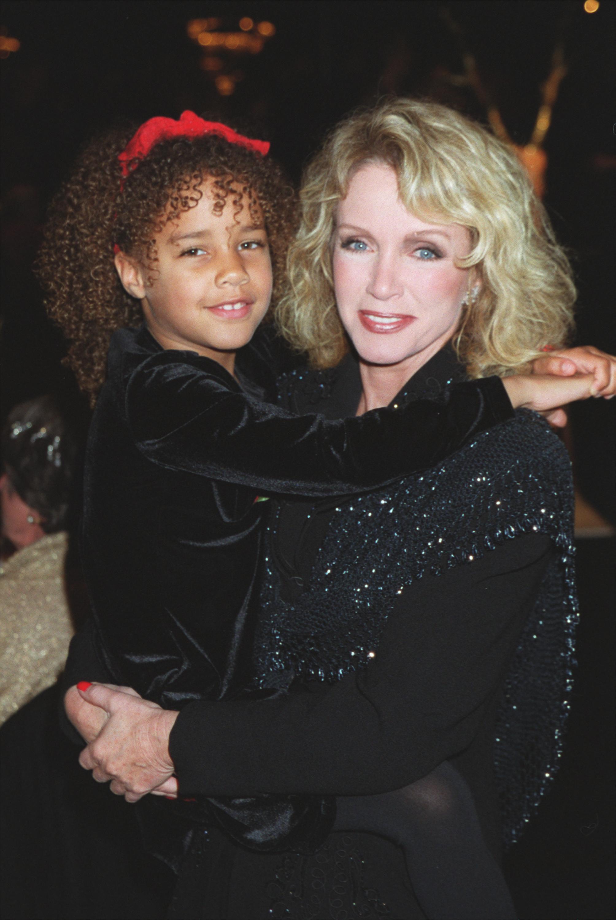 Actress Donna Mills and adopted daughter Chloe pose for a picture during "Merv Griffins 7th Annual Christmas Tree Lane Lighting Ceremony and Live Auction of Trees" December 12, 2000 in Beverly Hills, California | Source: Getty Images