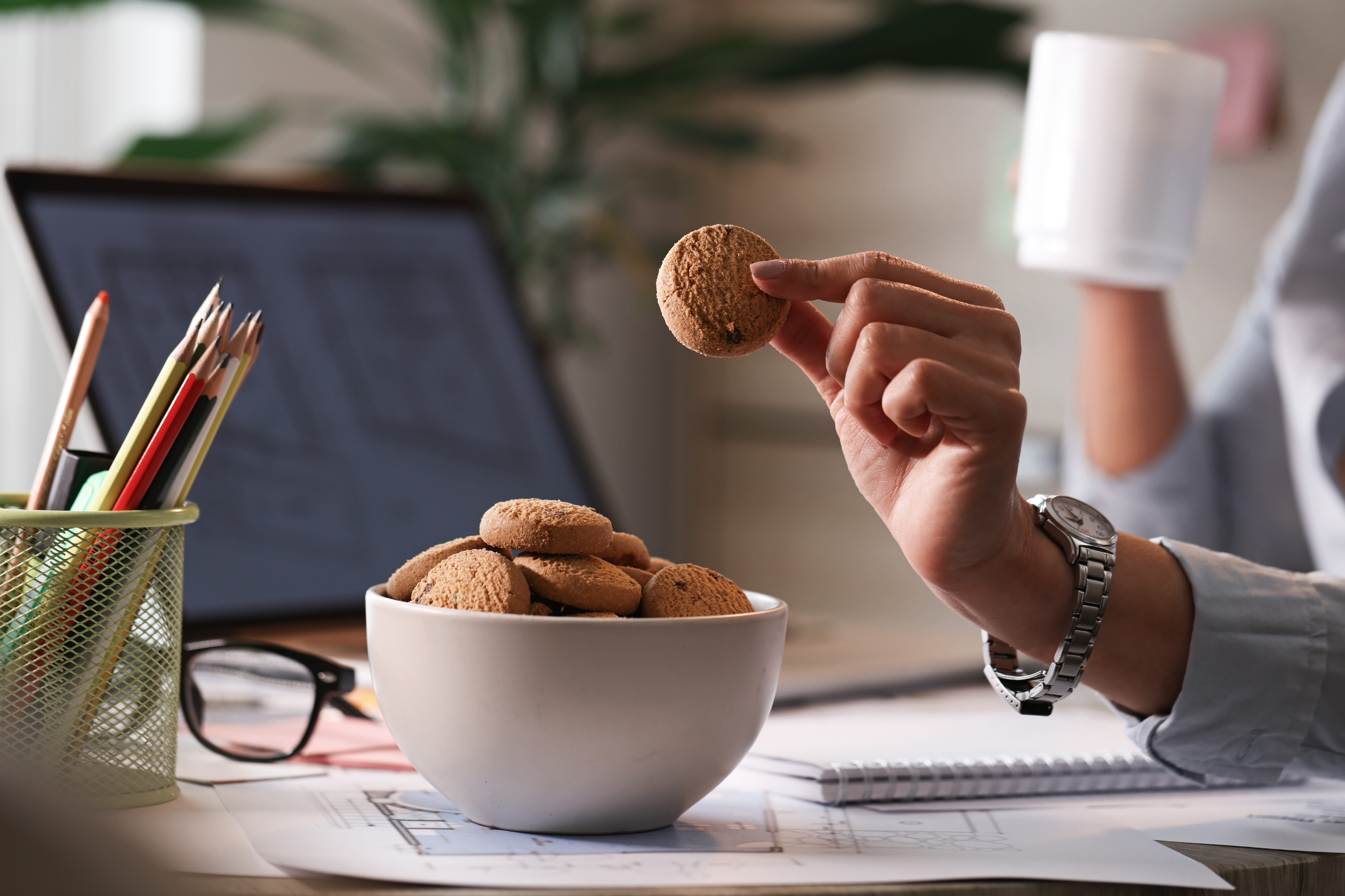 A person having cookies at the office | Source: Shutterstock