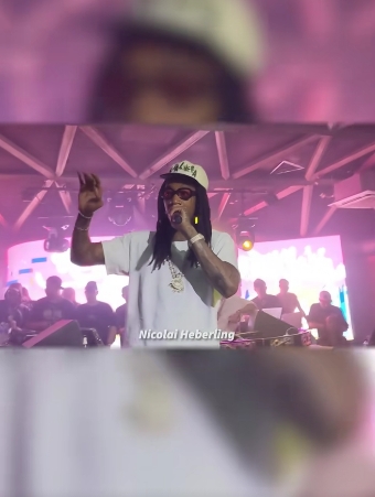 Wiz Khalifa pauses his performance to address a fan who had been throwing money onto the stage in a video dated November 26, 2024. | Source: TikTok/tmz