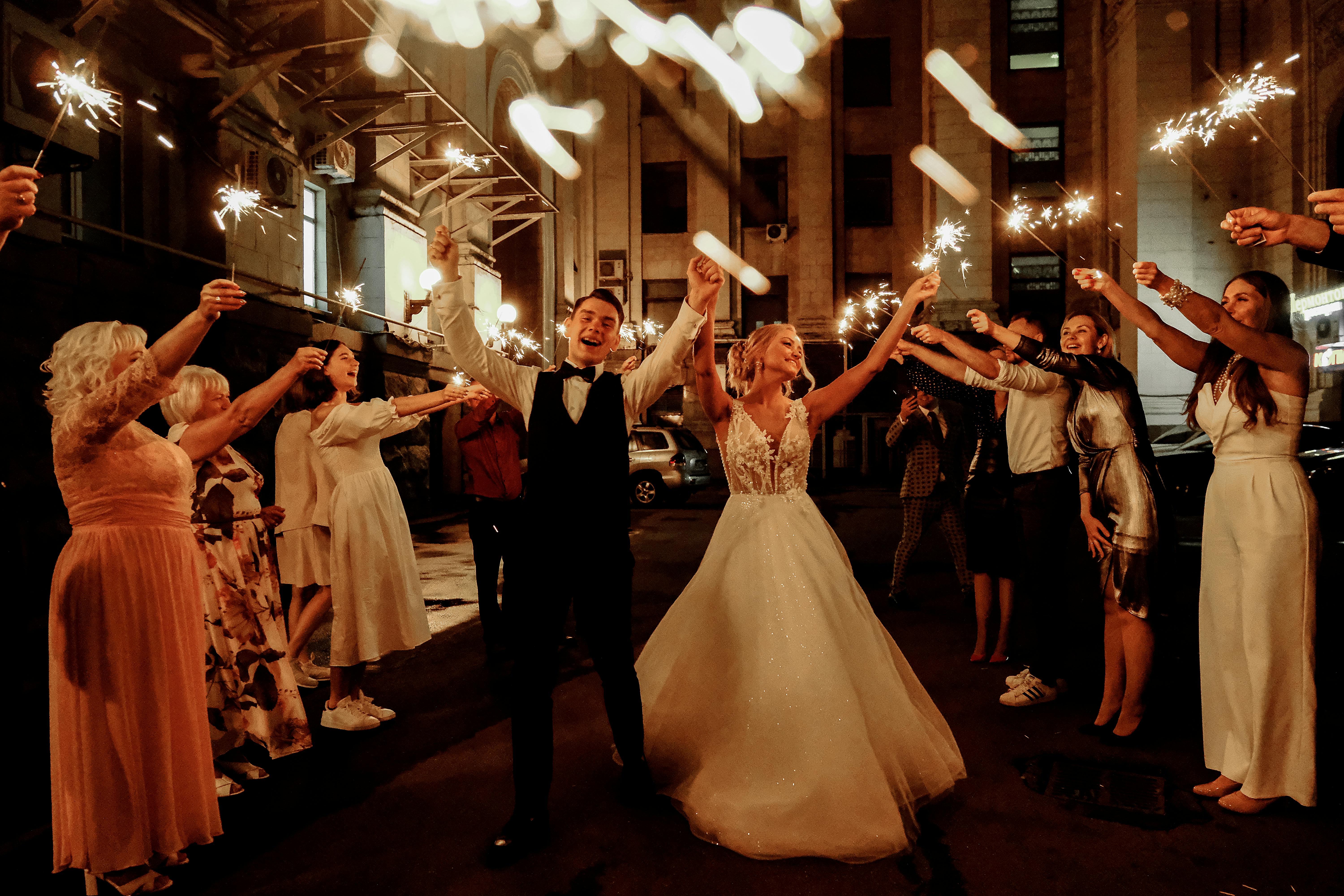 Guests and newlywed couple celebrating wedding at night  | Source: Pexels