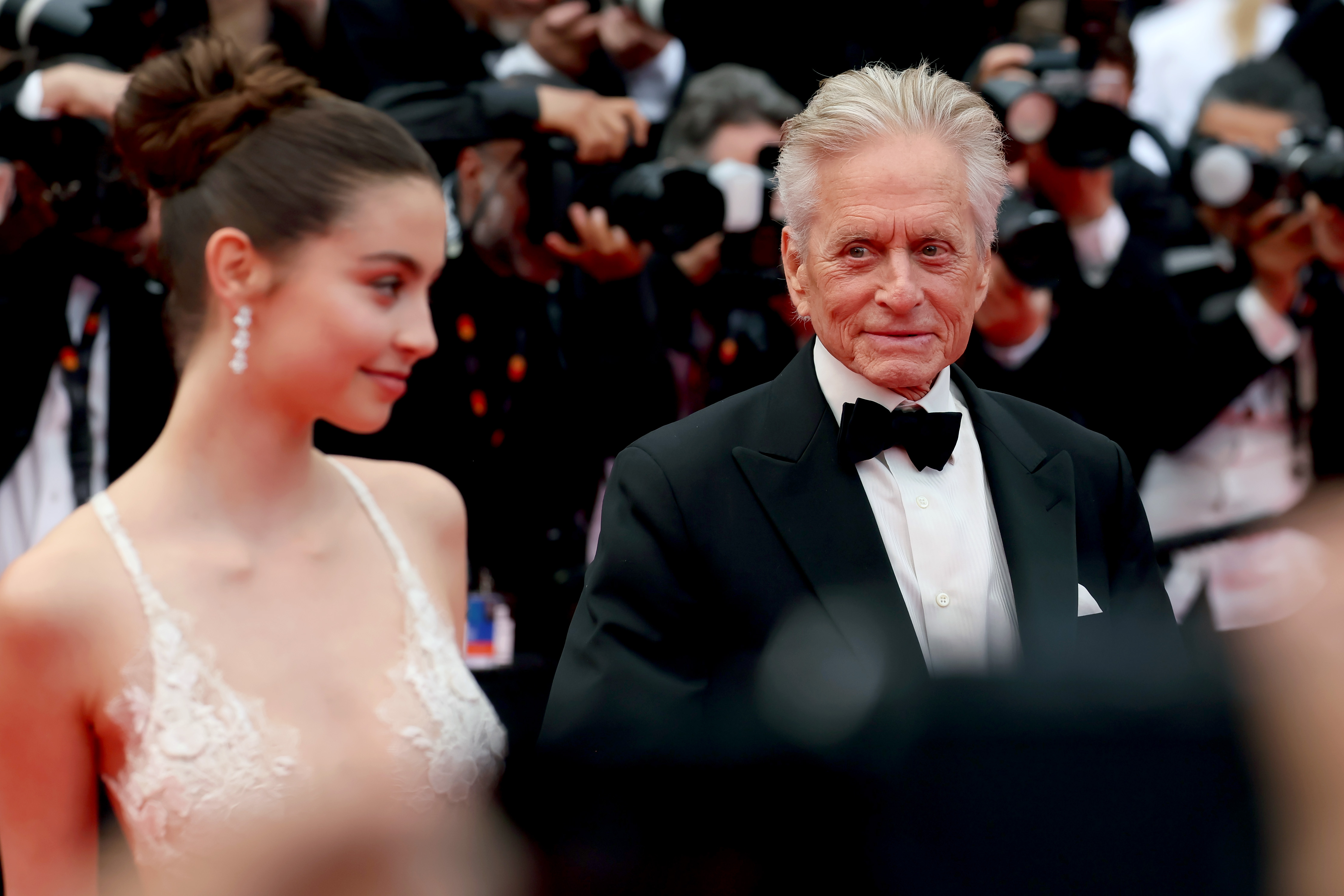 Carys Zeta and Michael Douglas attend the "Jeanne du Barry" Screening & opening ceremony red carpet at the 76th annual Cannes film festival in France | Source: Getty Images