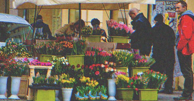 People shopping in a flowers' stand | Source: Shutterstock