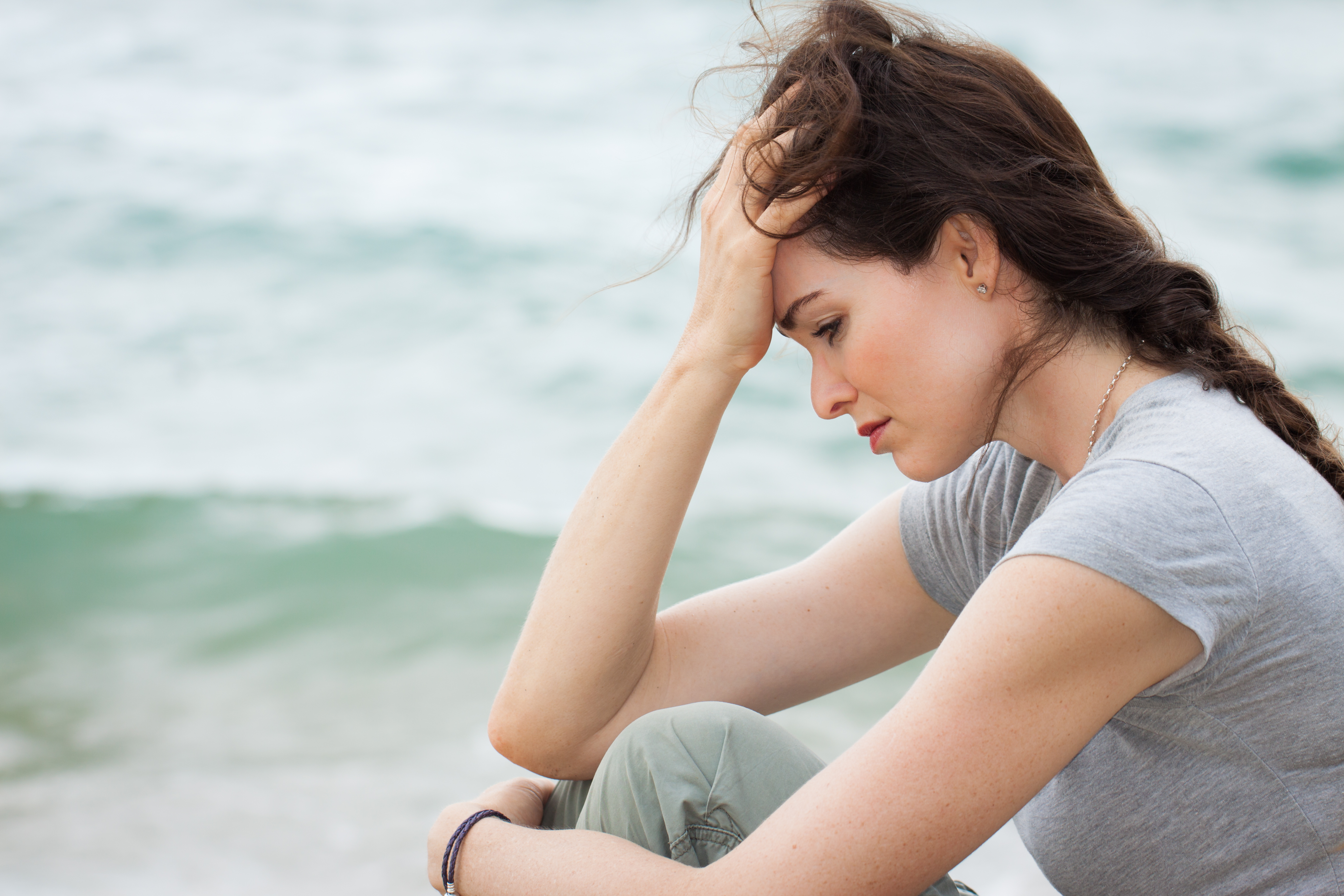 A depressed woman lost in thoughts | Source: Shutterstock