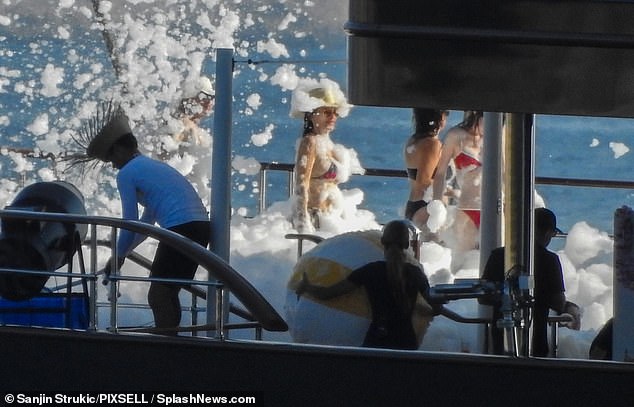 The couple embraced the foam on board the superyacht