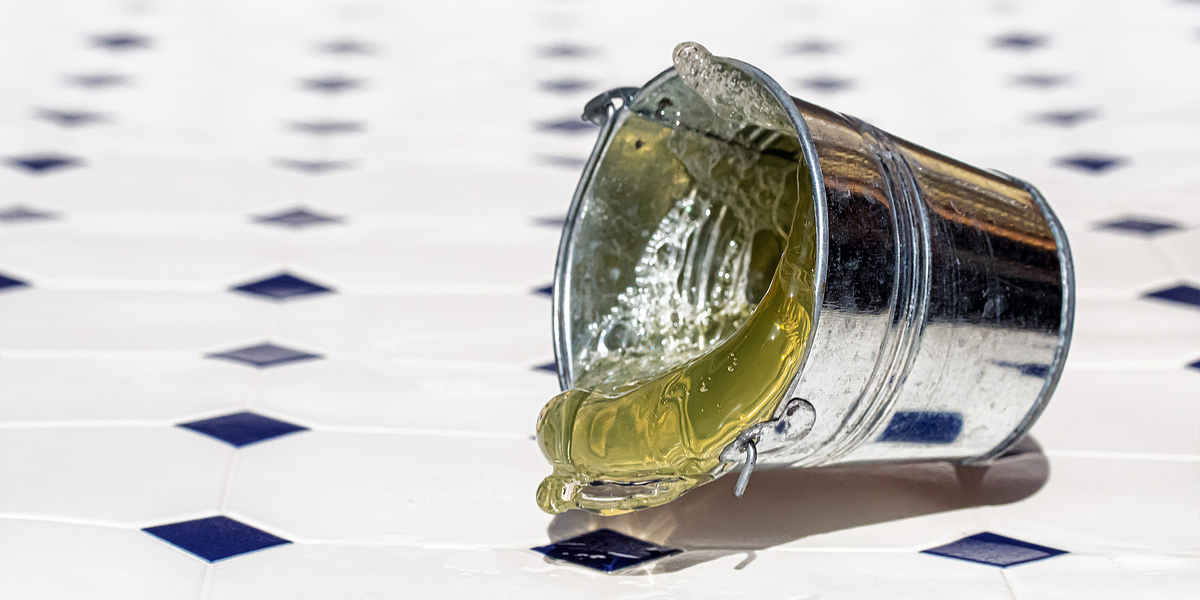 A silver bucket on a supermarket floor | Source: Shutterstock