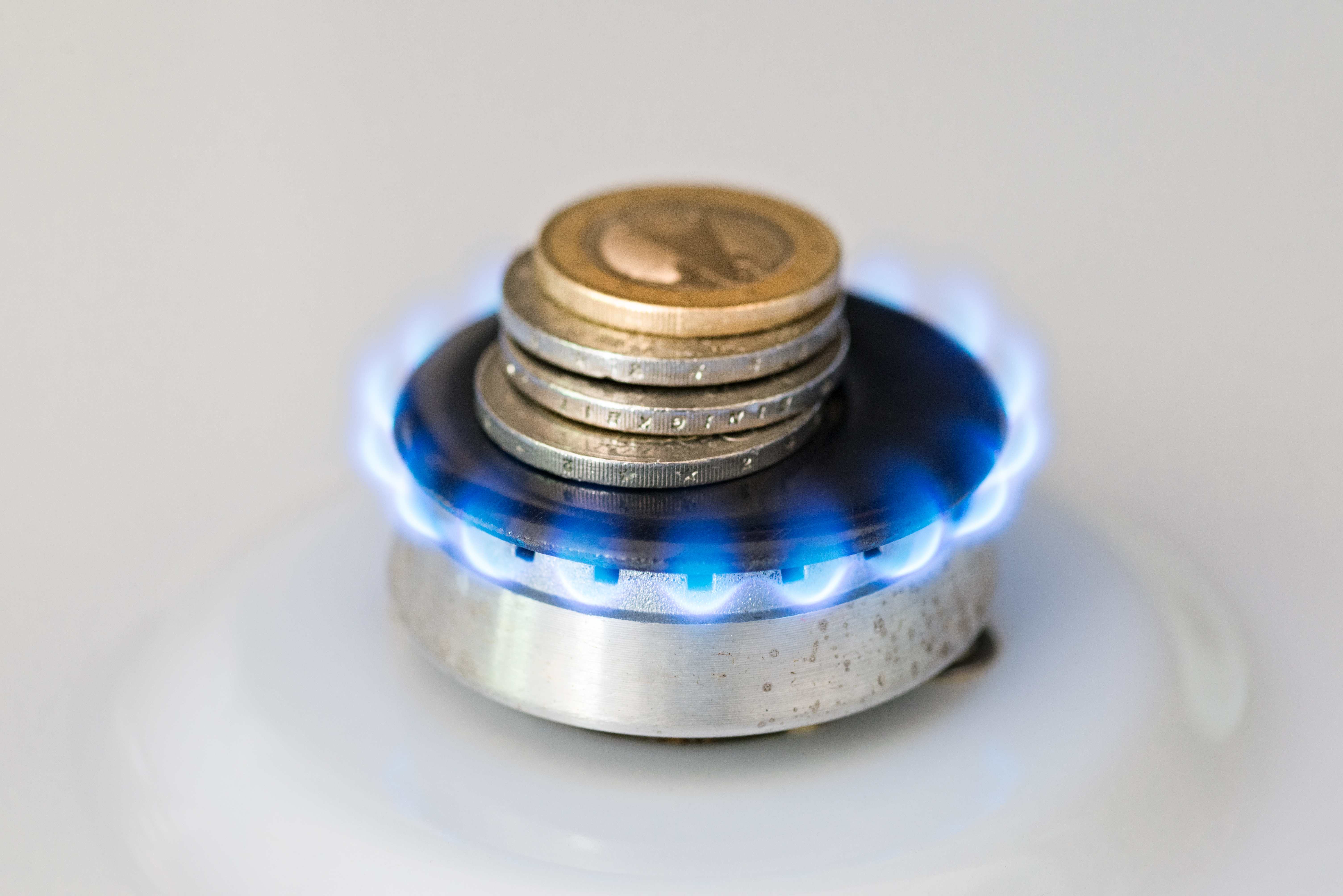 A gas burner with coins stacked on top of it | Source: Getty Images