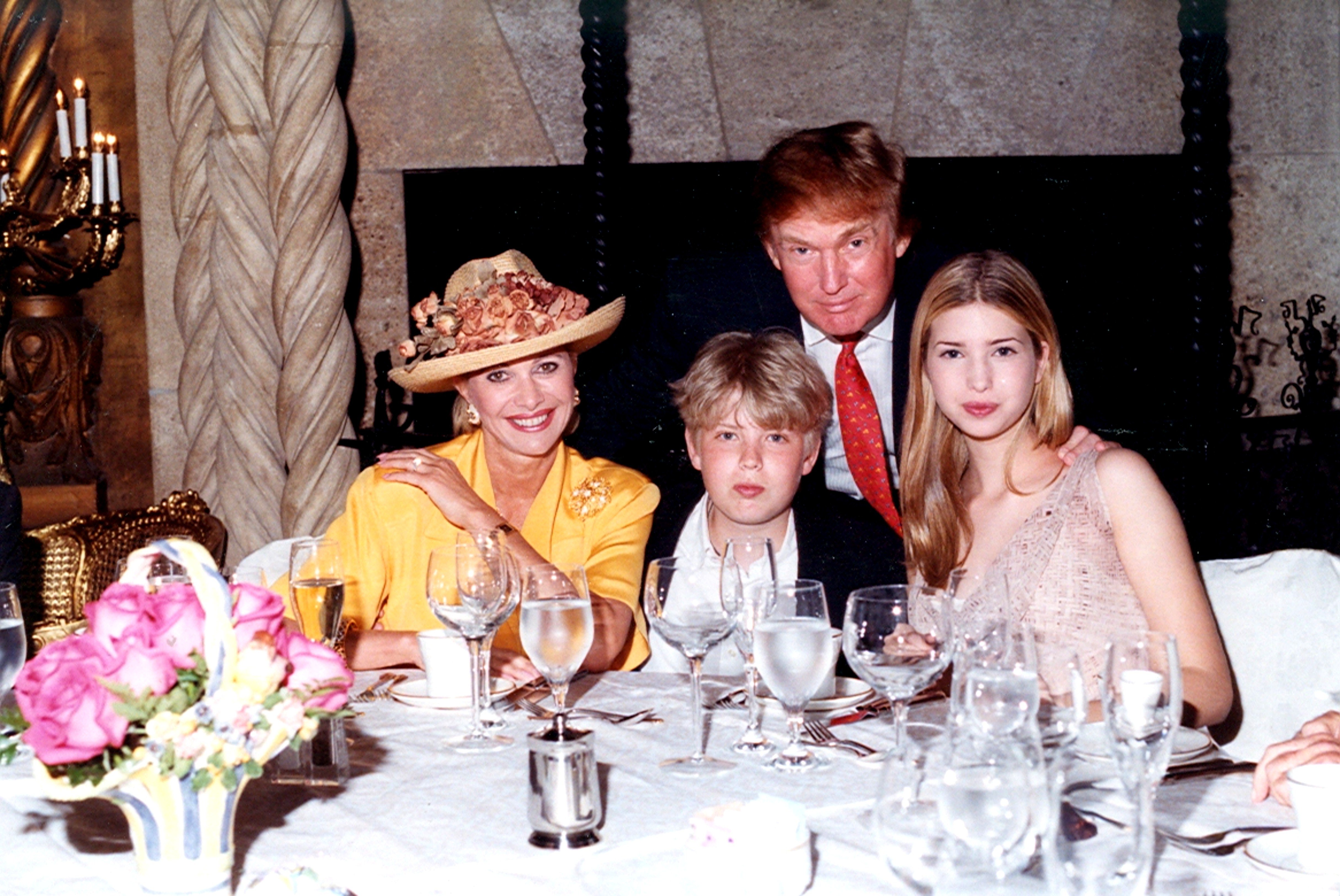 Family portrait of socialite Ivana Trump, her son Eric Trump, her former husband, businessman Donald Trump, and her daughter Ivanka Trump seated at a table at Mar-a-Lago Estate, Palm Beach , Florida, 1998. |  Source: Getty Images