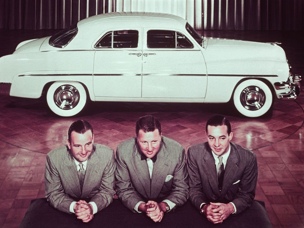 Henry Ford II, with brothers, Benson, and William Clay posed in front of 1950 automobile, circa 1950 | Photo: Getty Images