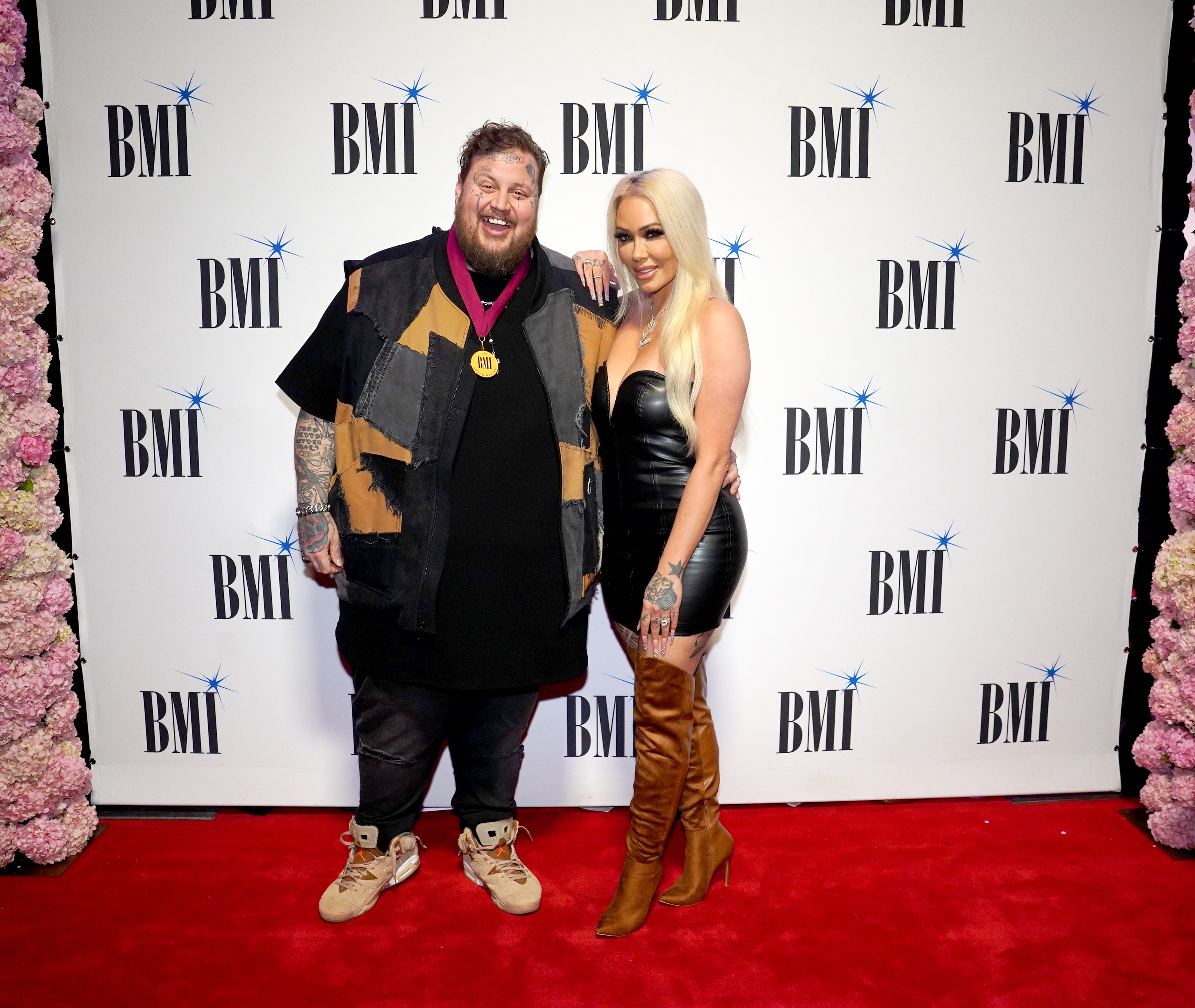 Jelly Roll and Bunnie XO pose together at an event. Bunnie later revealed that despite their divorce, they plan to live on the same compound and raise their future child as one big family. | Source: Getty Images