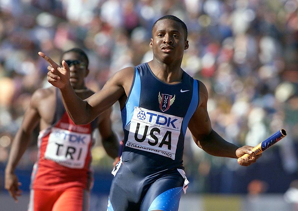 United States 4x100M anchor runner Tim Montgomery crosses the finish line to win the men's 4x100M final at the 8th World Championships in Athletics 12 August, 2001, in Commonwealth Stadium in Edmonton, Canada | Photo: Getty Images