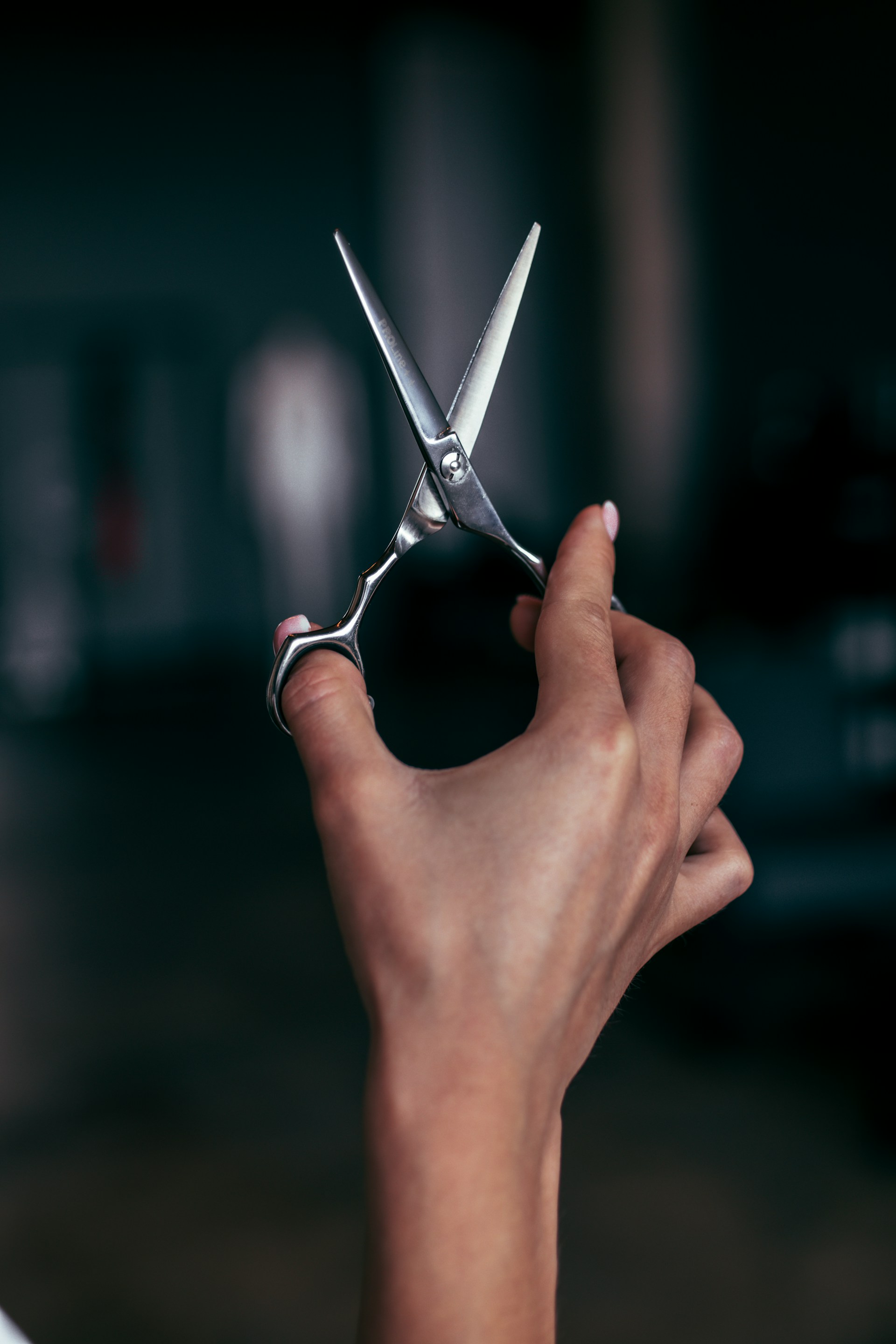 A woman holding a pair of scissors | Source: Unsplash