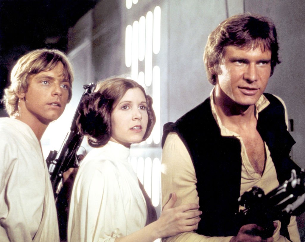 Mark Hamill, Carrie Fisher and Harrison Ford portraying their "Star Wars" characters in "Star Wars: Episode IV - A New Hope" in 1977. | Source: Getty Images