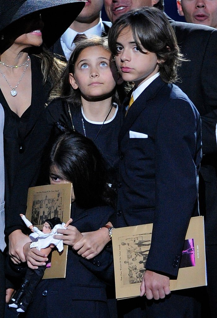 A young Prince Jackson with his siblings Paris and Blanket at the public memorial service for their father, Michael Jackson at the Staples Center on July 7, 2009. | Source: Getty