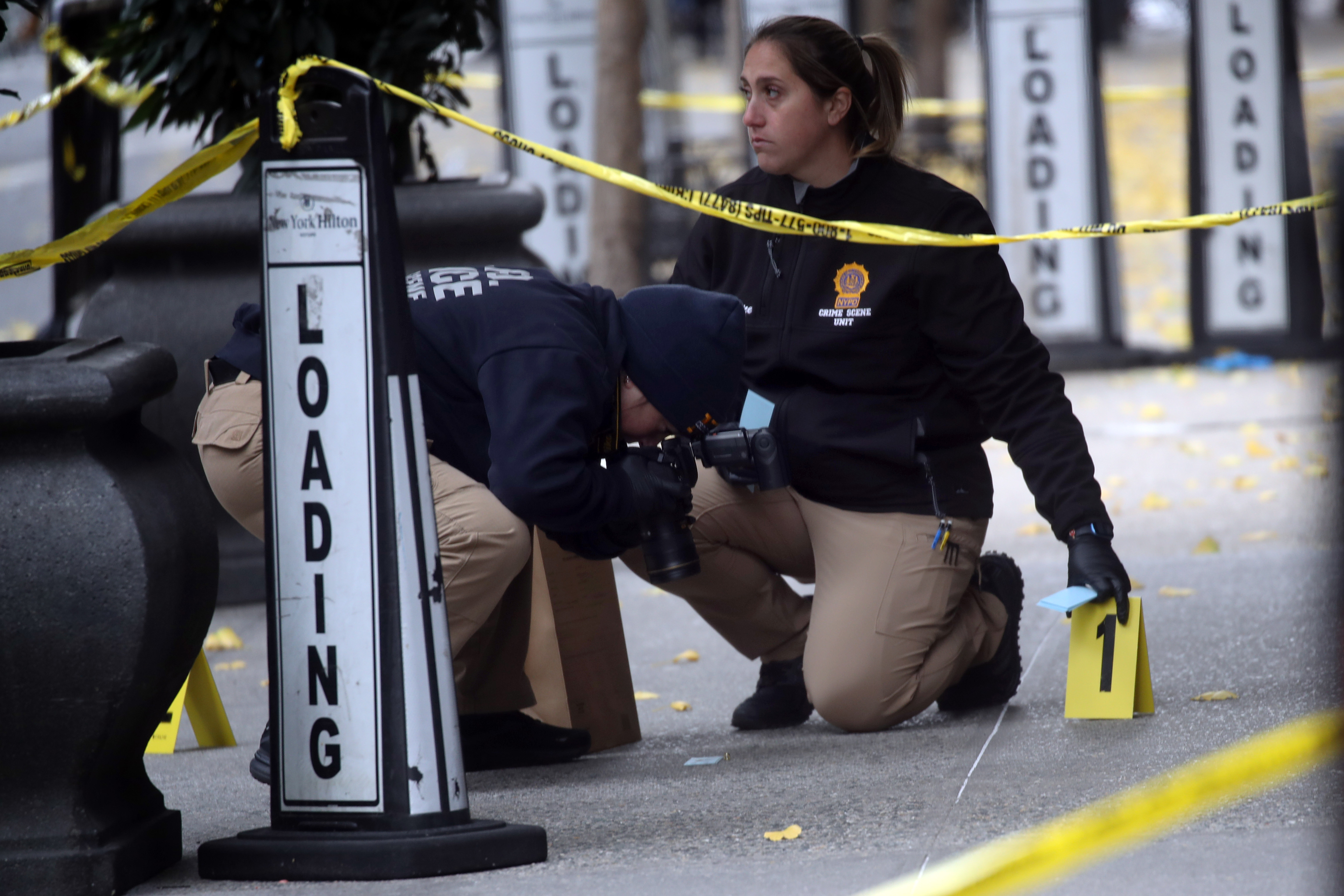 Police mark bullet casings outside a Hilton Hotel in Midtown Manhattan where UnitedHealthcare CEO Brian Thompson was fatally shot on December 4, 2024 | Source: Getty Images