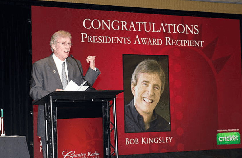 Bob Kingsley reads a speech as he receives the Presidents Award at the Country Radio Hall of Fame Dinner & Ceremony, on February 21, 2012 in Nashville, Tennessee | Source: Getty Images (Photo by Beth Gwinn/FilmMagic)