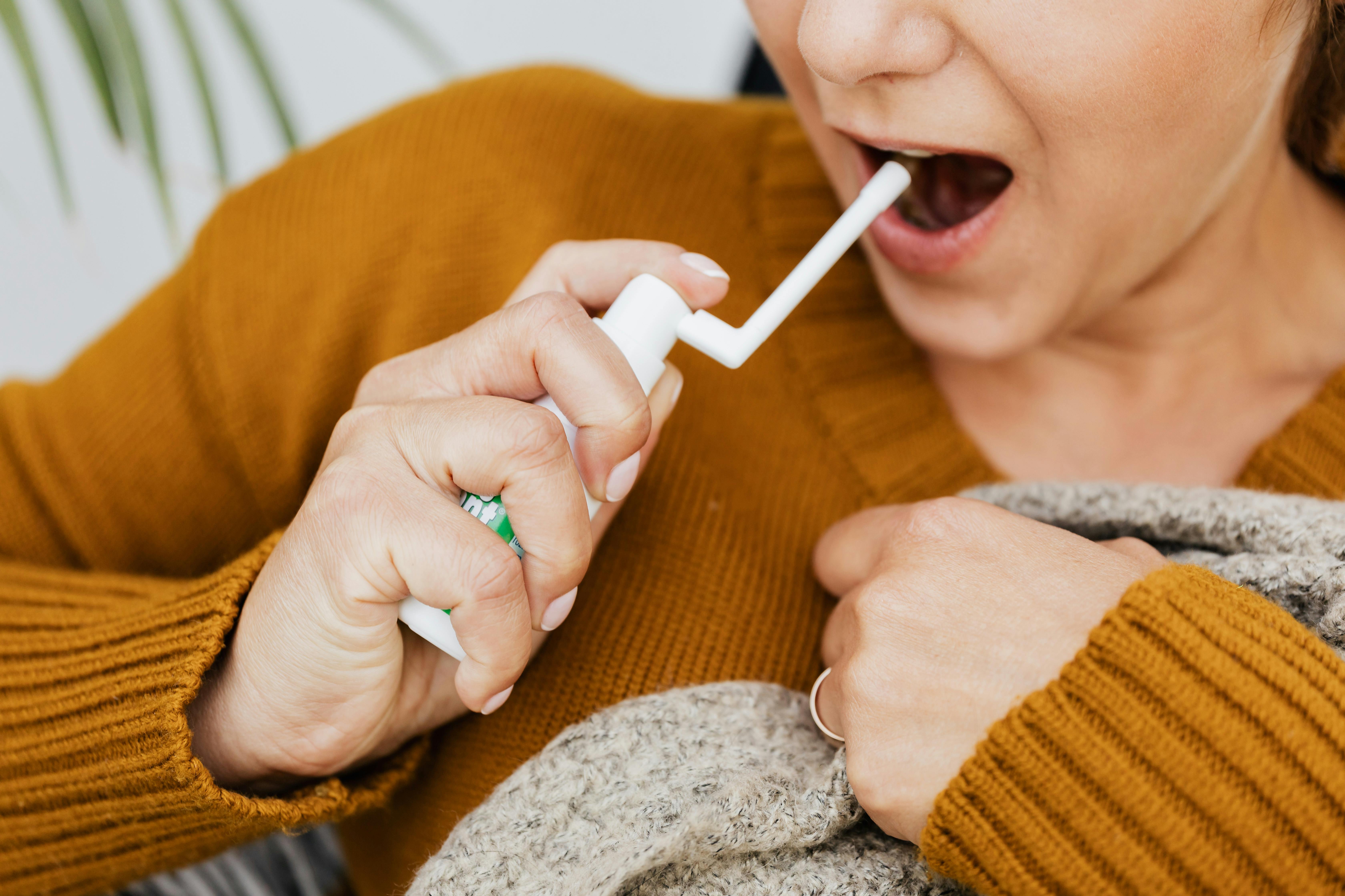 A woman taking sore throat medication | Source: Pexels
