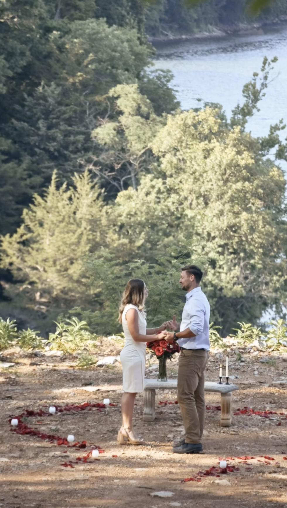 Inside a heart of rose petals and candles, Stephen Wissmann holds Jana Duggar’s hands as they face each other, sharing a tender moment in the open air. | Source: Instagram/janamduggar