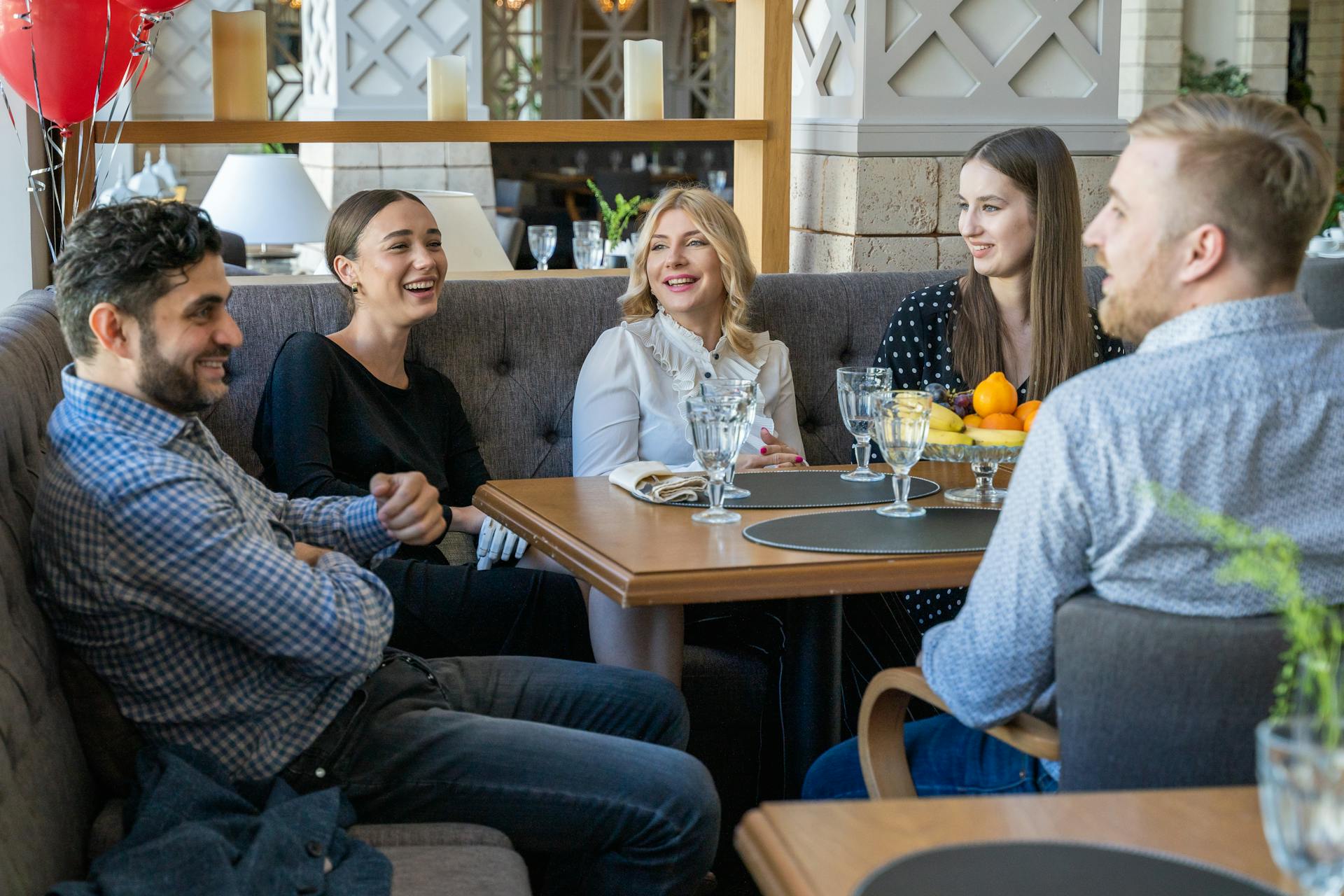 A group of work colleagues meet in a restaurant | Source: Pexels