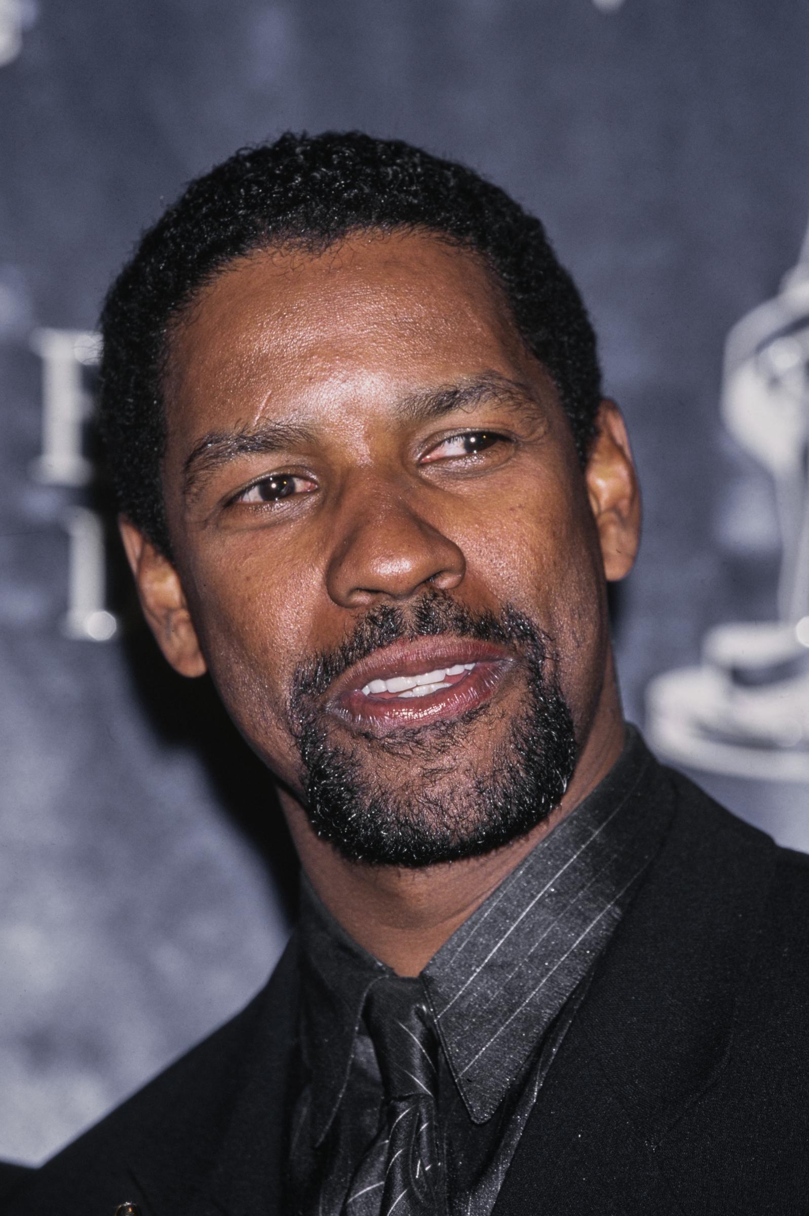 Denzel Washington accepts the "Actor of the Year" award at the ShoWest Awards. With a neatly edged-up cut and trimmed goatee, the actor's grooming matched his rising stature as one of Hollywood's most bankable stars.