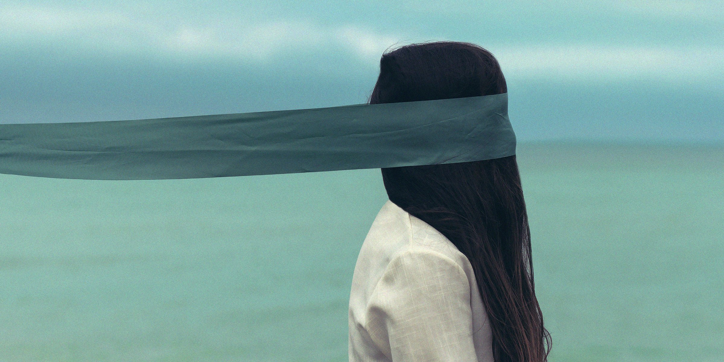 An individual standing with their eyes blindfolded. | Source: Unsplash