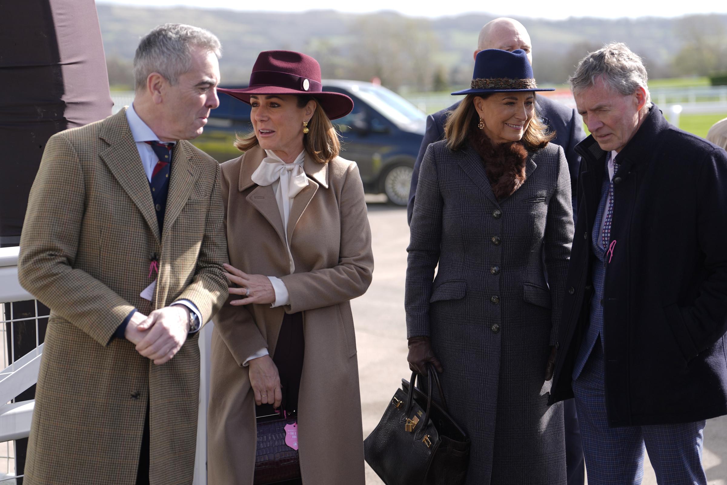 Carole Middleton commands attention in the Princess of Wales's blue Hicks & Brown fedora and a sleek longline grey check coat, her signature dark Hermès Birkin bag firmly in hand, as she strolls alongside actor James Nesbitt and broadcaster Natalie Pinkham on Day 2 of the 2026 Cheltenham Festival at Cheltenham Racecourse on Wednesday, 11 March.