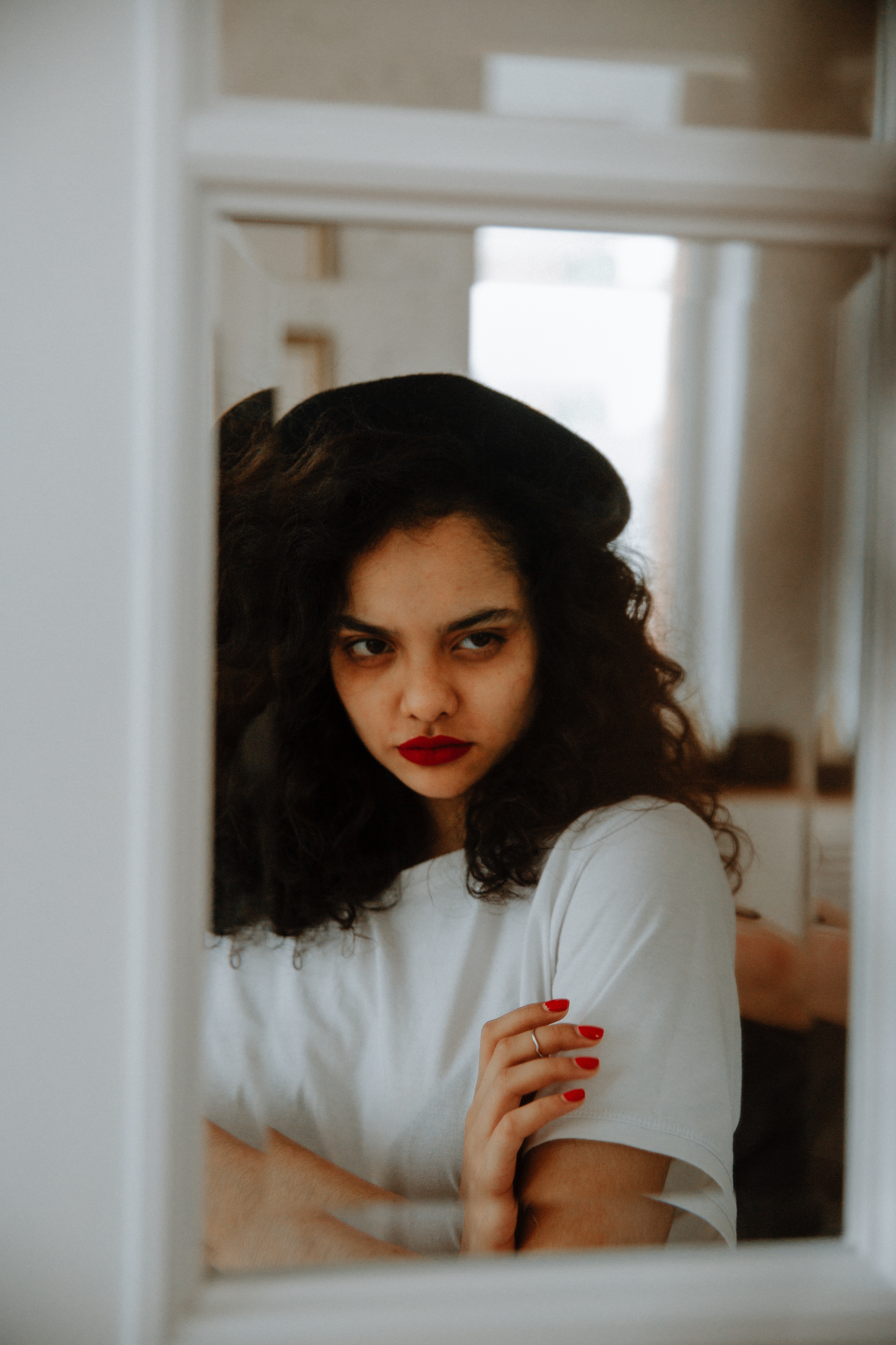 A woman looking angrily in the mirror.│Source: Pexels