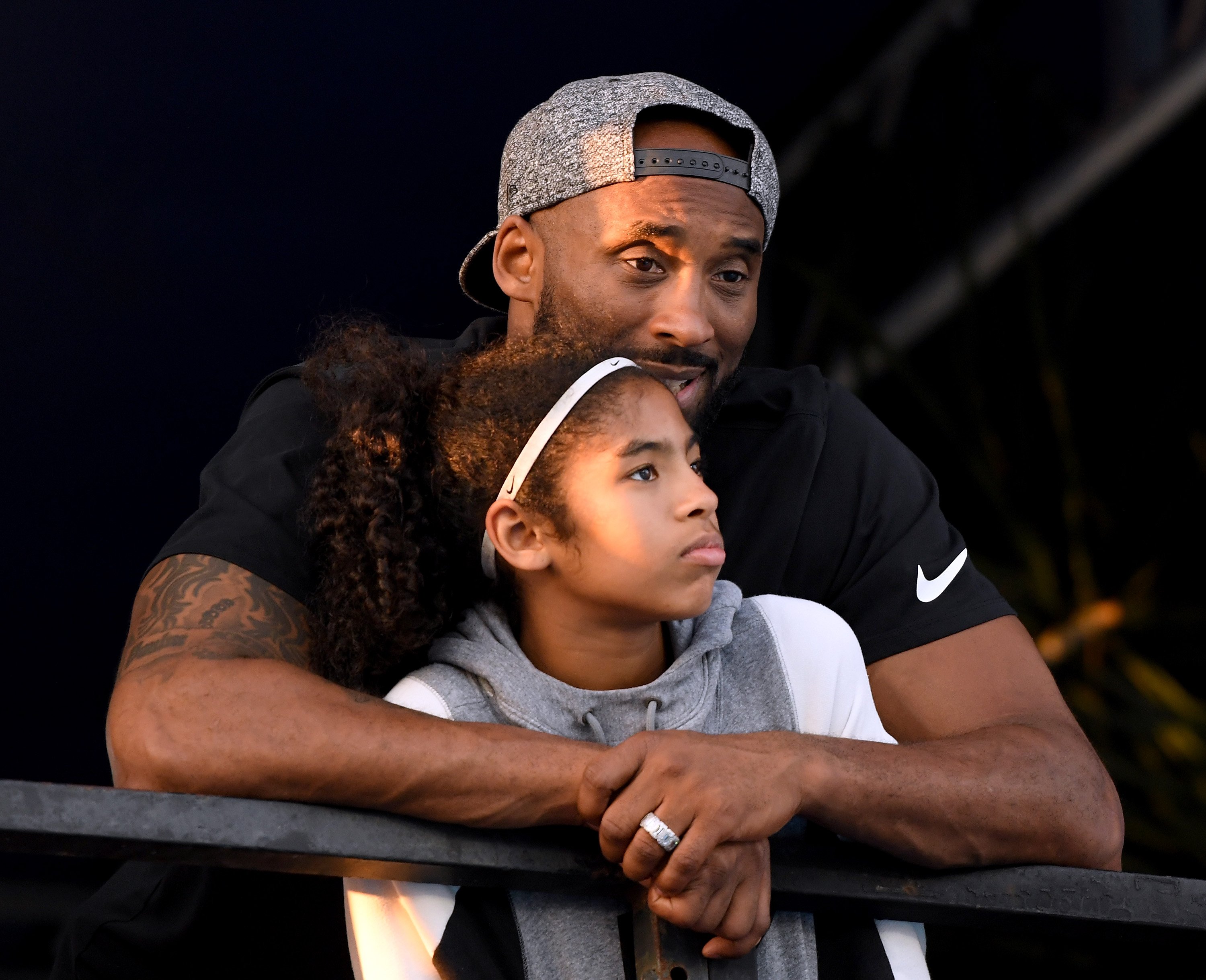 Kobe Bryant and daughter Gianna Bryant watch during day 2 of the Phillips 66 National Swimming Championships. | Photo: GettyImages