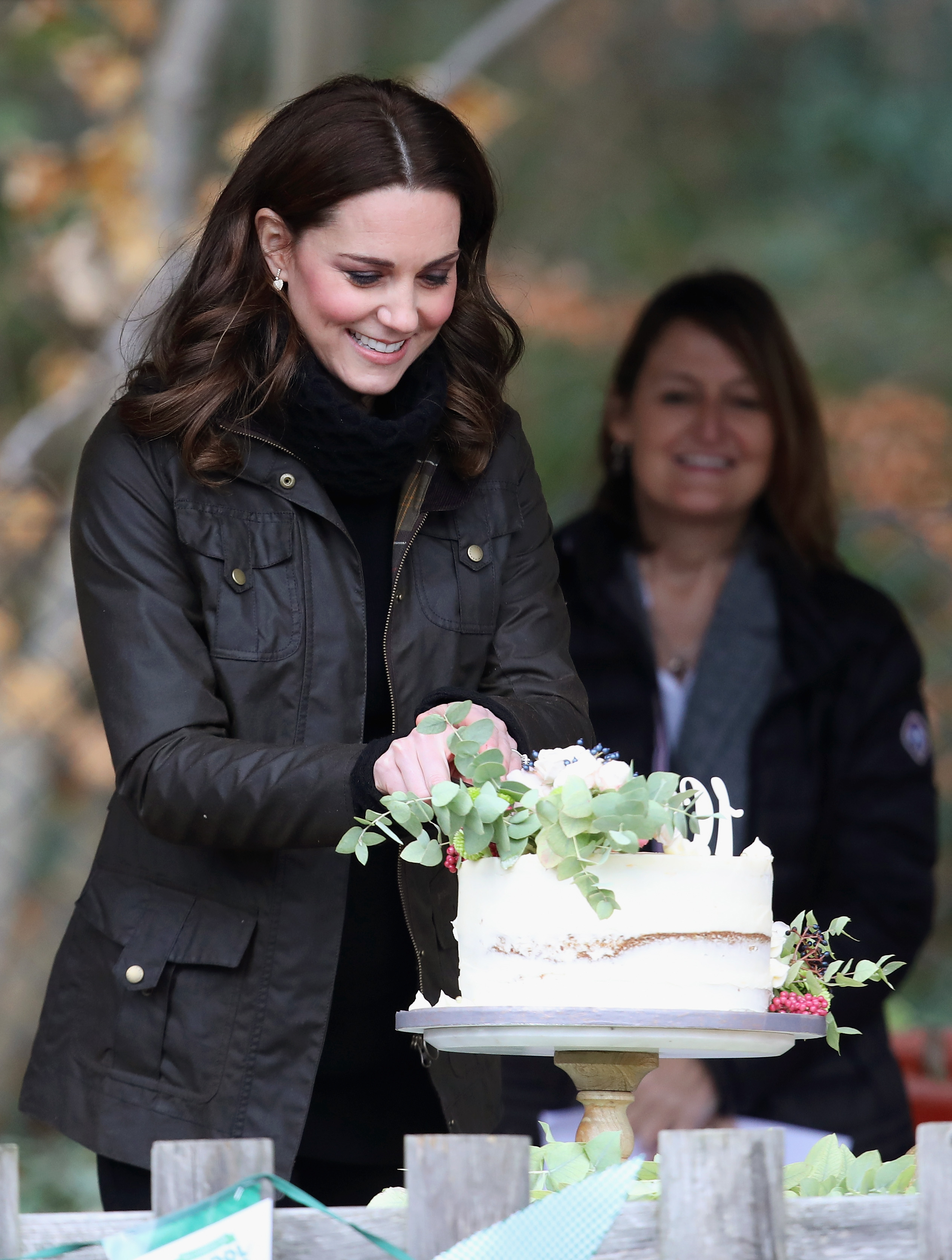 Kate Middleton cutting a cake during her visit to the Robin Hood Primary School in London, England on November 29, 2017 | Source: Getty Images