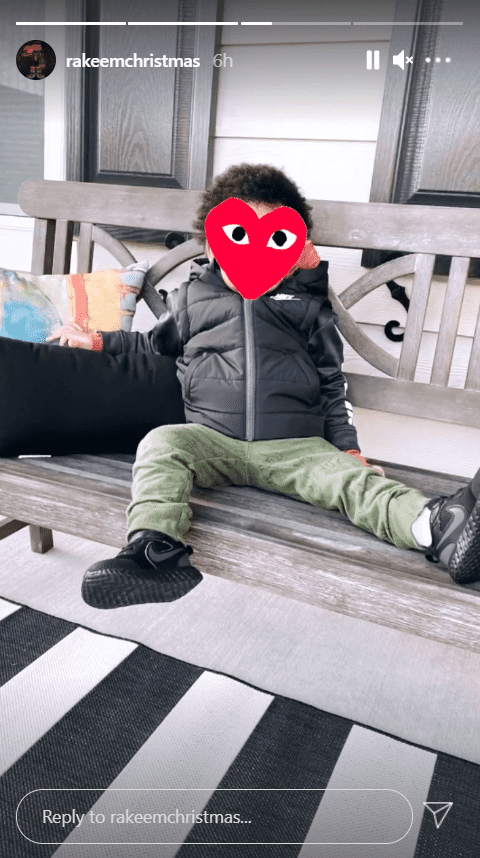 A picture of Jasmine Jordan's son, Rakeem, seated on a bench with his face covered with a red heart emoji  | Photo: Instagram/rakeemchristmas