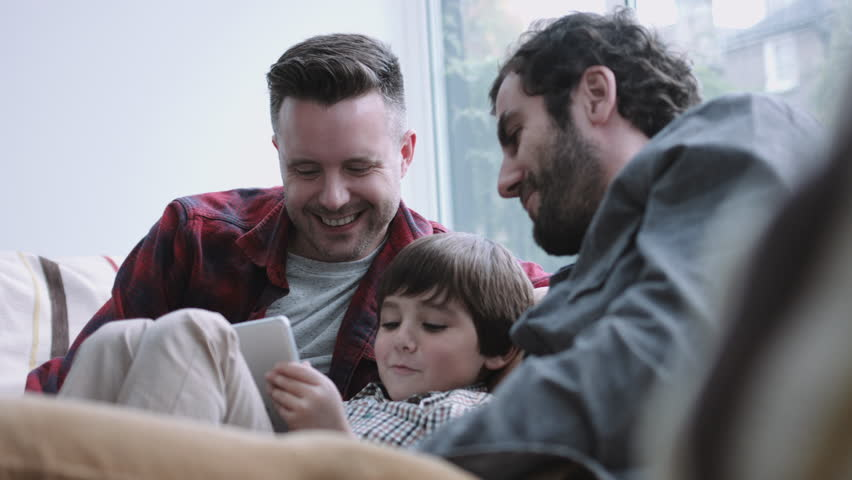 Gay couple having fun with their child | Photo: Shutterstock