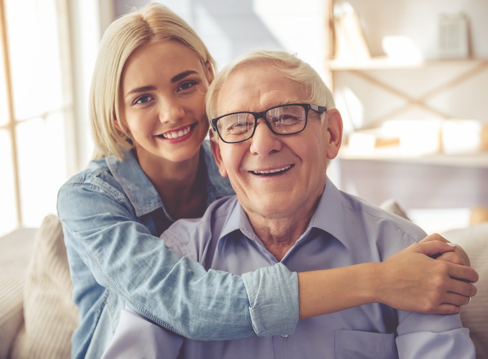 Senior man with young woman | Source: Shutterstock