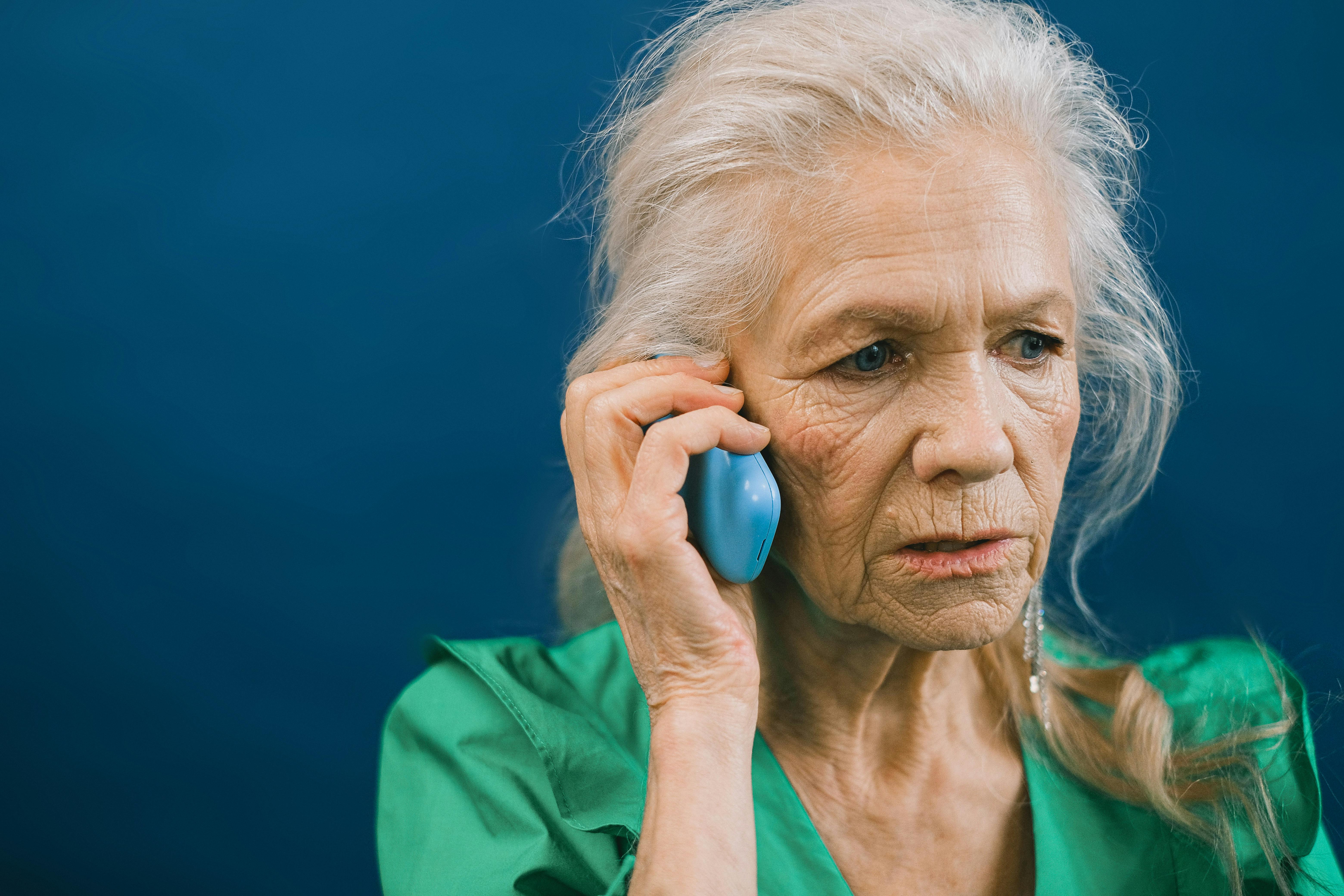 A sad elderly woman on a phone call | Source: Pexels