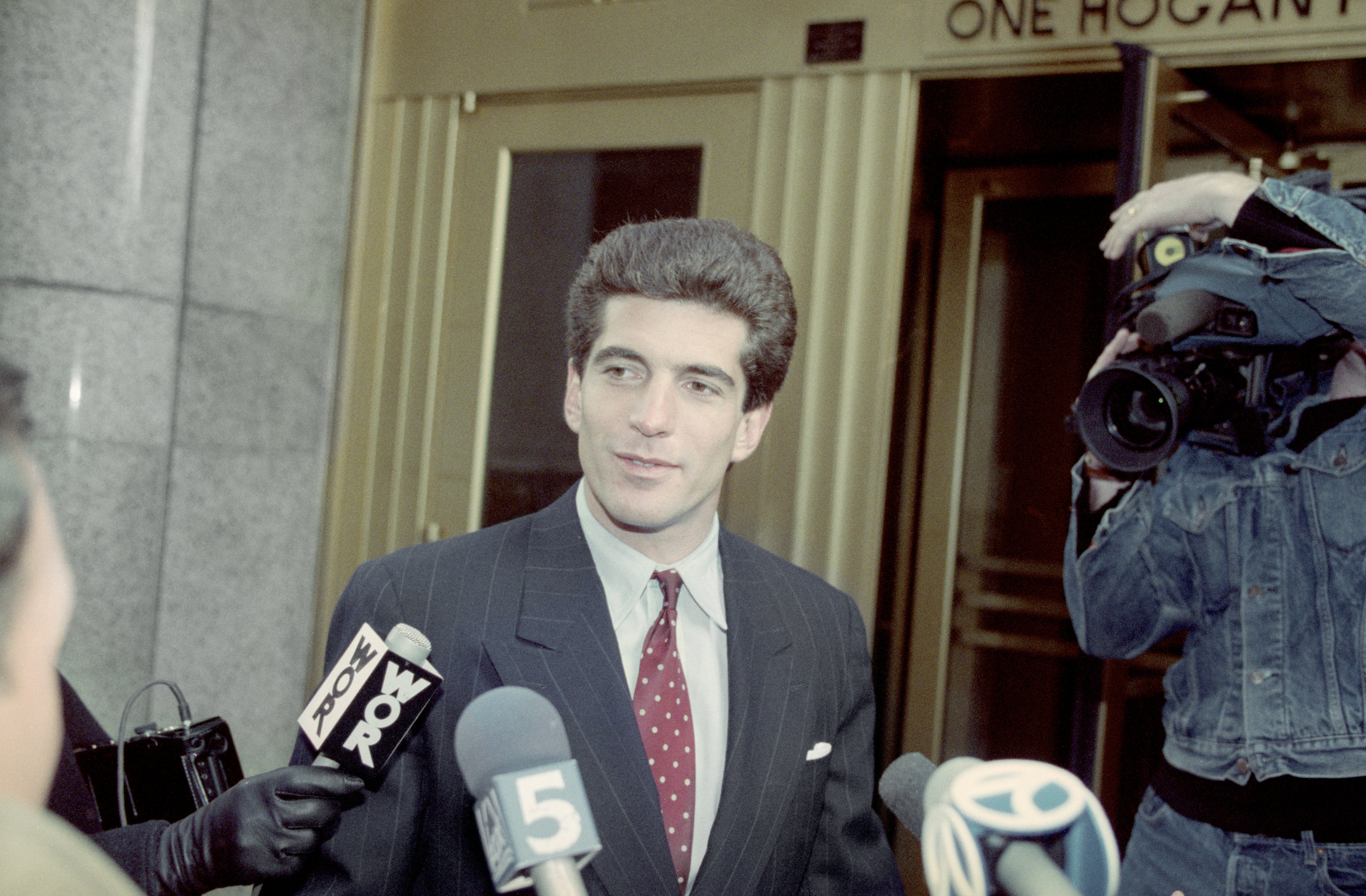 John F. Kennedy Jr. talks to reporters about passing the New York Bar examination | Photo: Getty Images