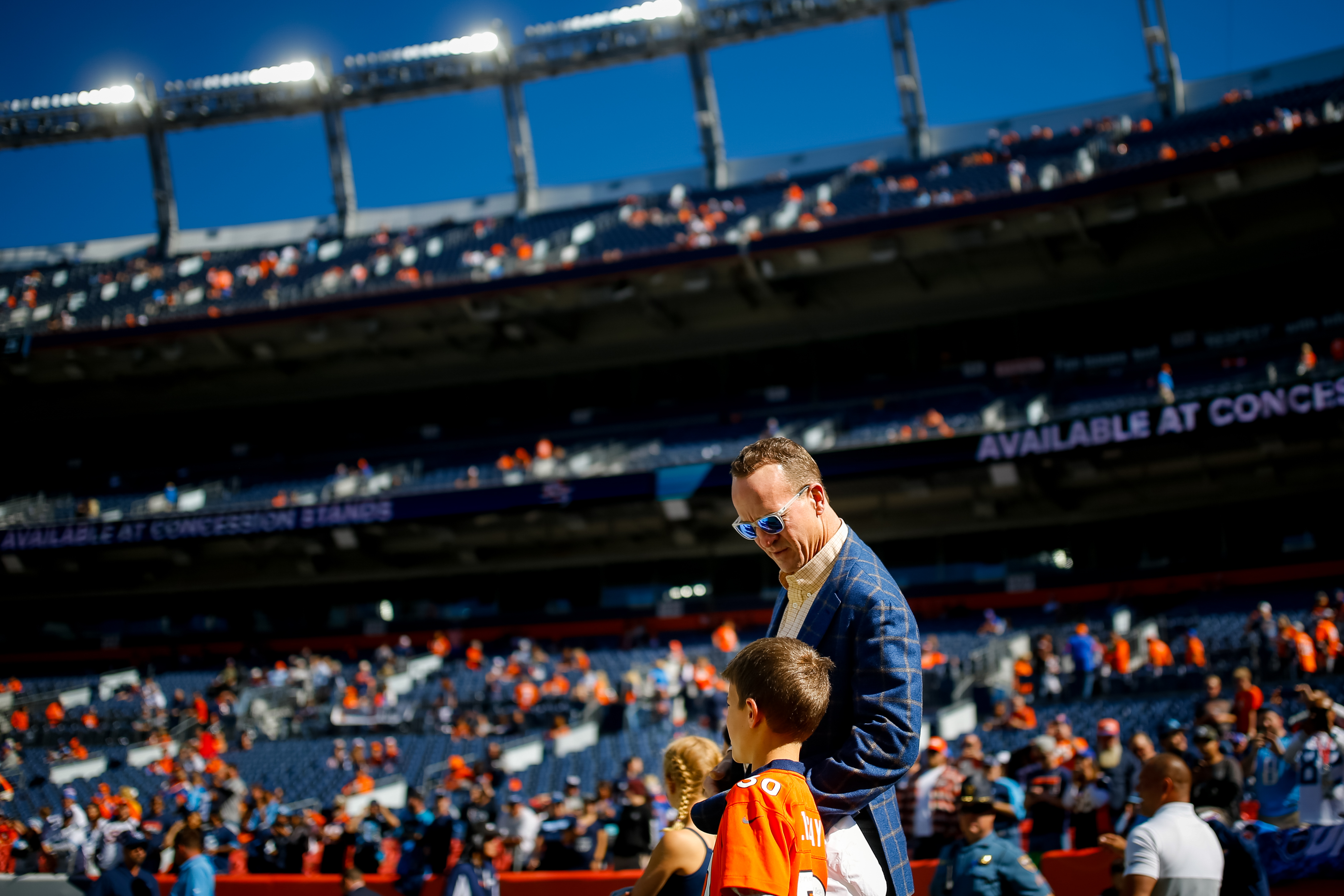 Peyton Manning is pictured as he talks with his son Marshall Manning on the field before a game against the Tennessee Titans at Empower Field at Mile High on October 13, 2019, in Denver, Colorado | Source: Getty Images