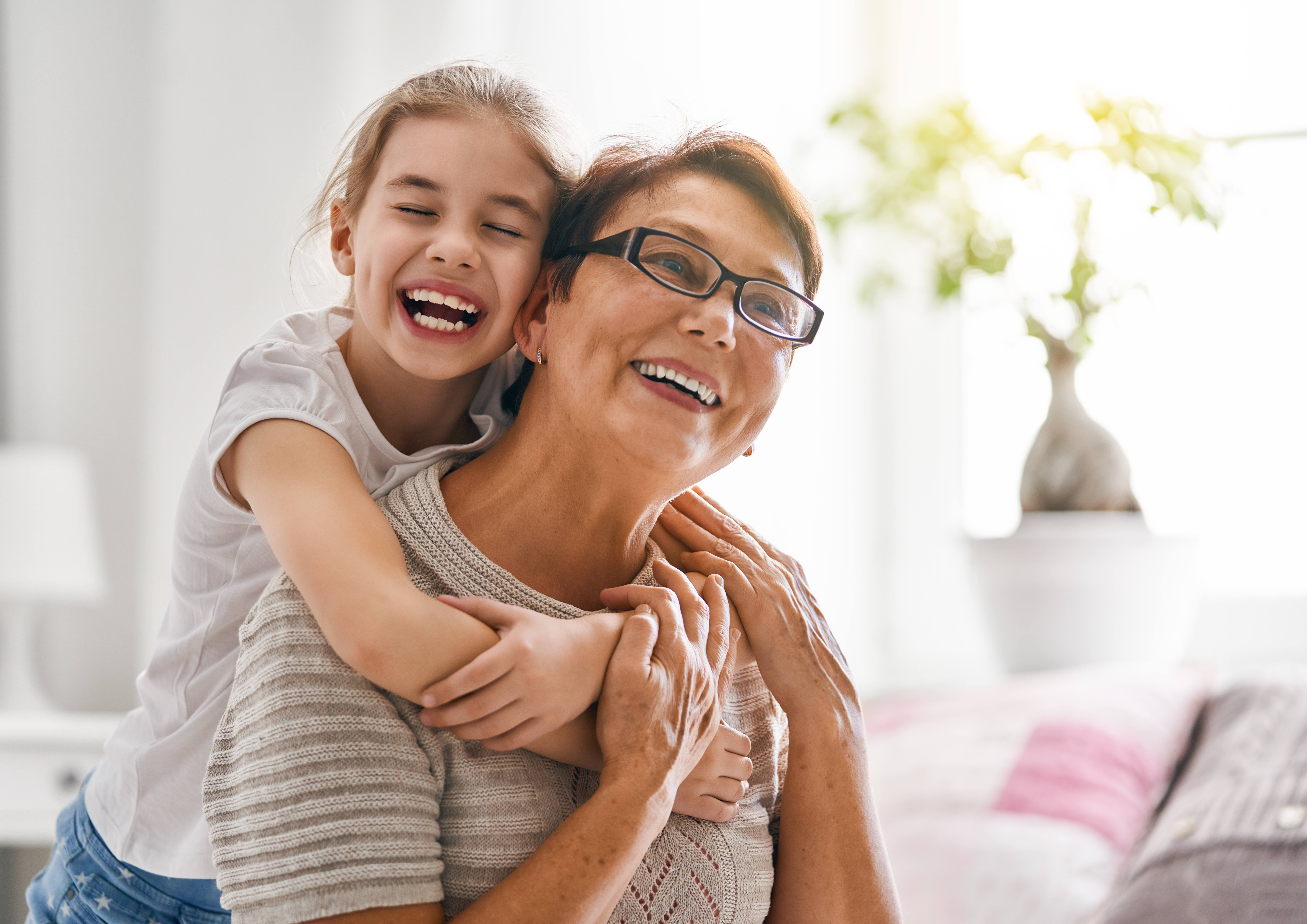 A little girl and her grandmother smiling | Source: Shutterstock