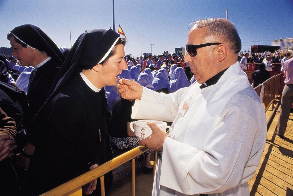 Priest giving the communion | Source: Getty Images