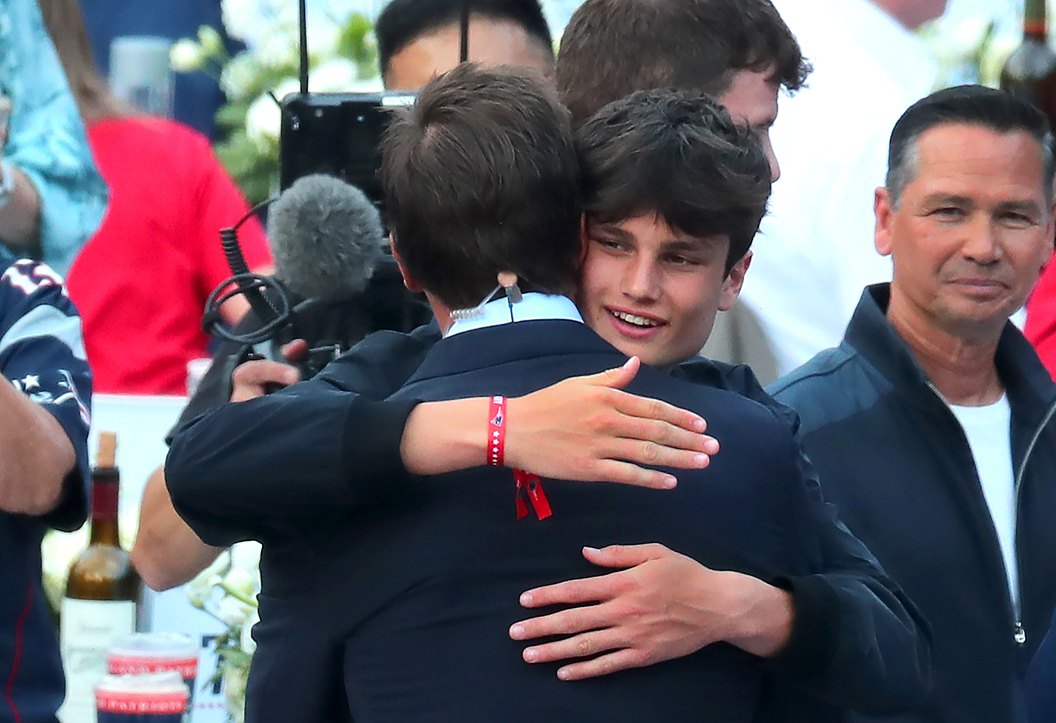 Tom Brady hugs Jack Moynahan at his Patriots Hall of Fame induction ceremony at Gillette Stadium, on June 12, 2024 | Source: Getty Images