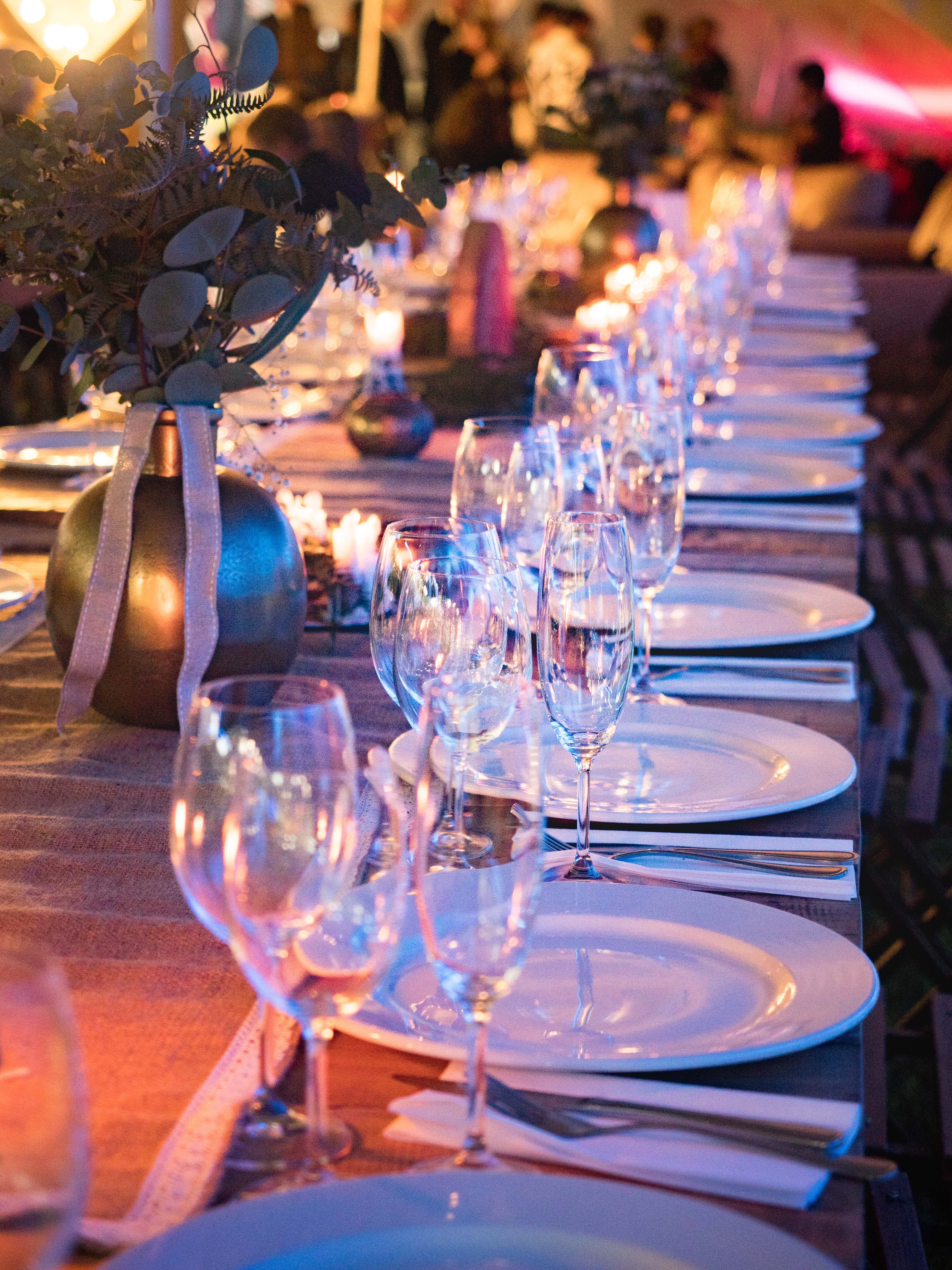 A table arrangement with glasses and plates at an outdoor event | Source: Pexels