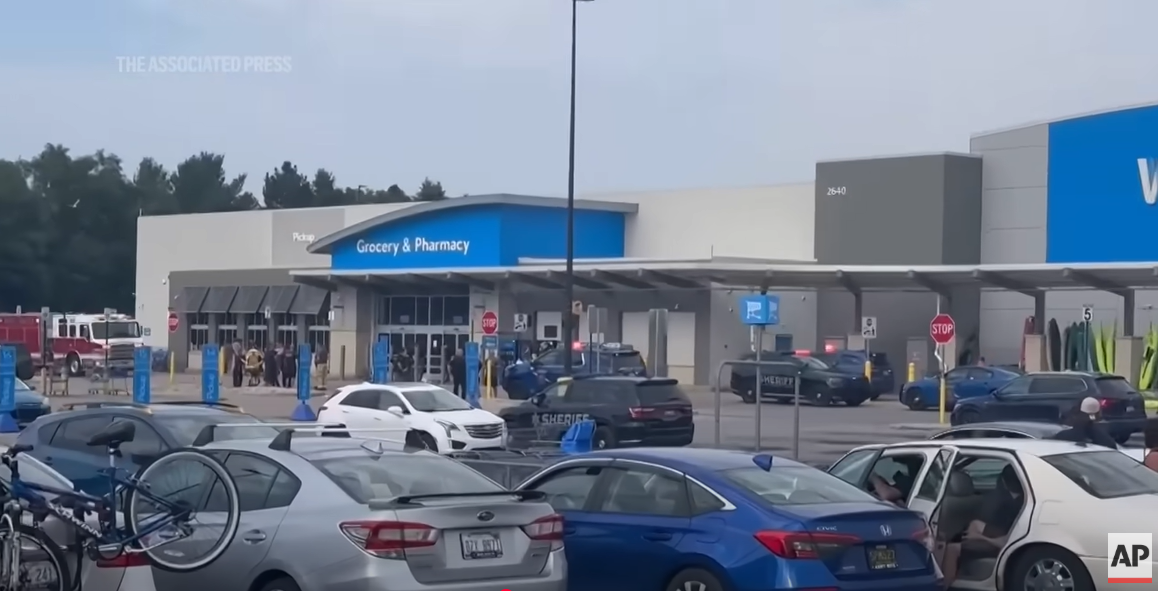 Police cars, and ambulances seen at the Walmart scene, from a video posted on July 27, 2025 | Source: YouTube/AssociatedPress