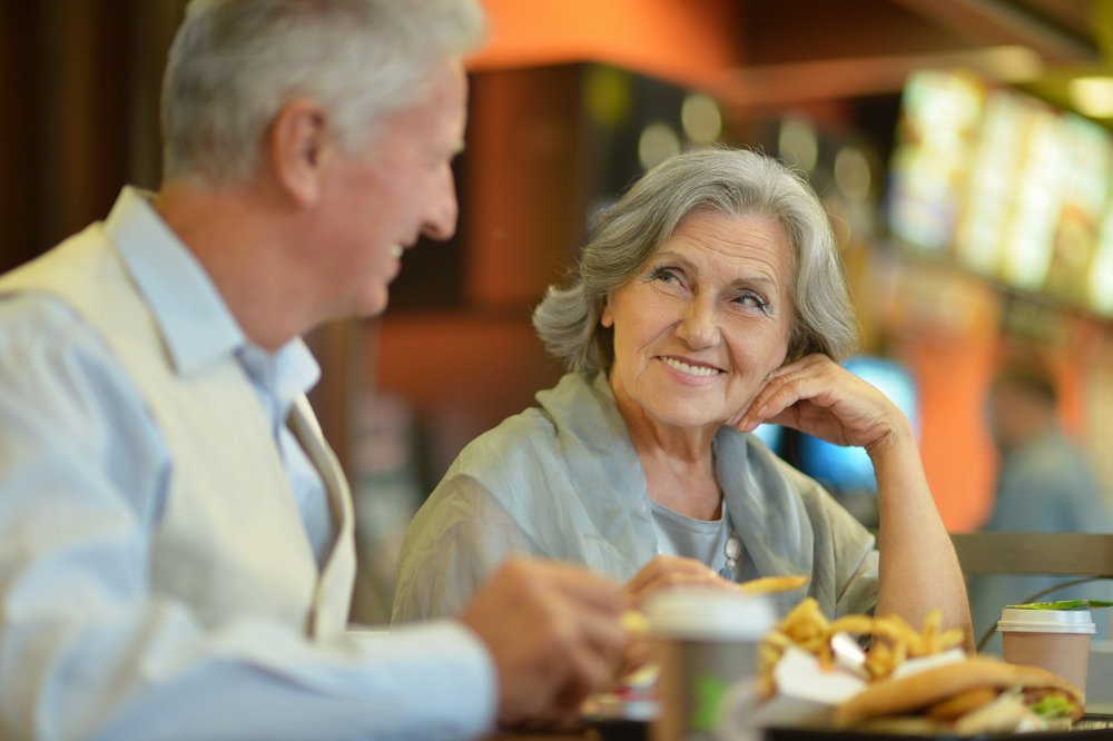 Elderly couple exchanging a glance at a restaurant | Photo: Shutterstock