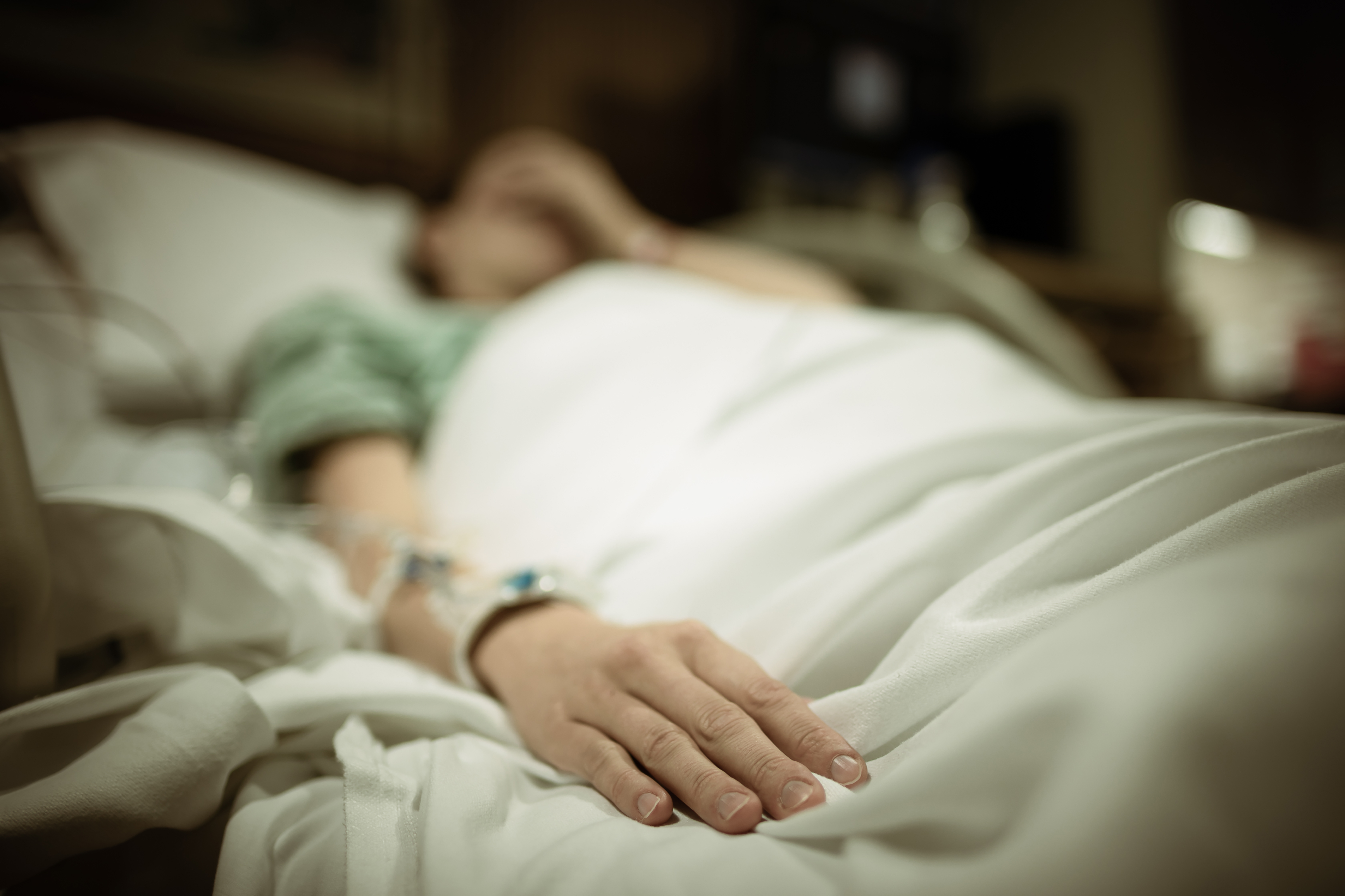 Sad woman in hospital bed | Source: Shutterstock